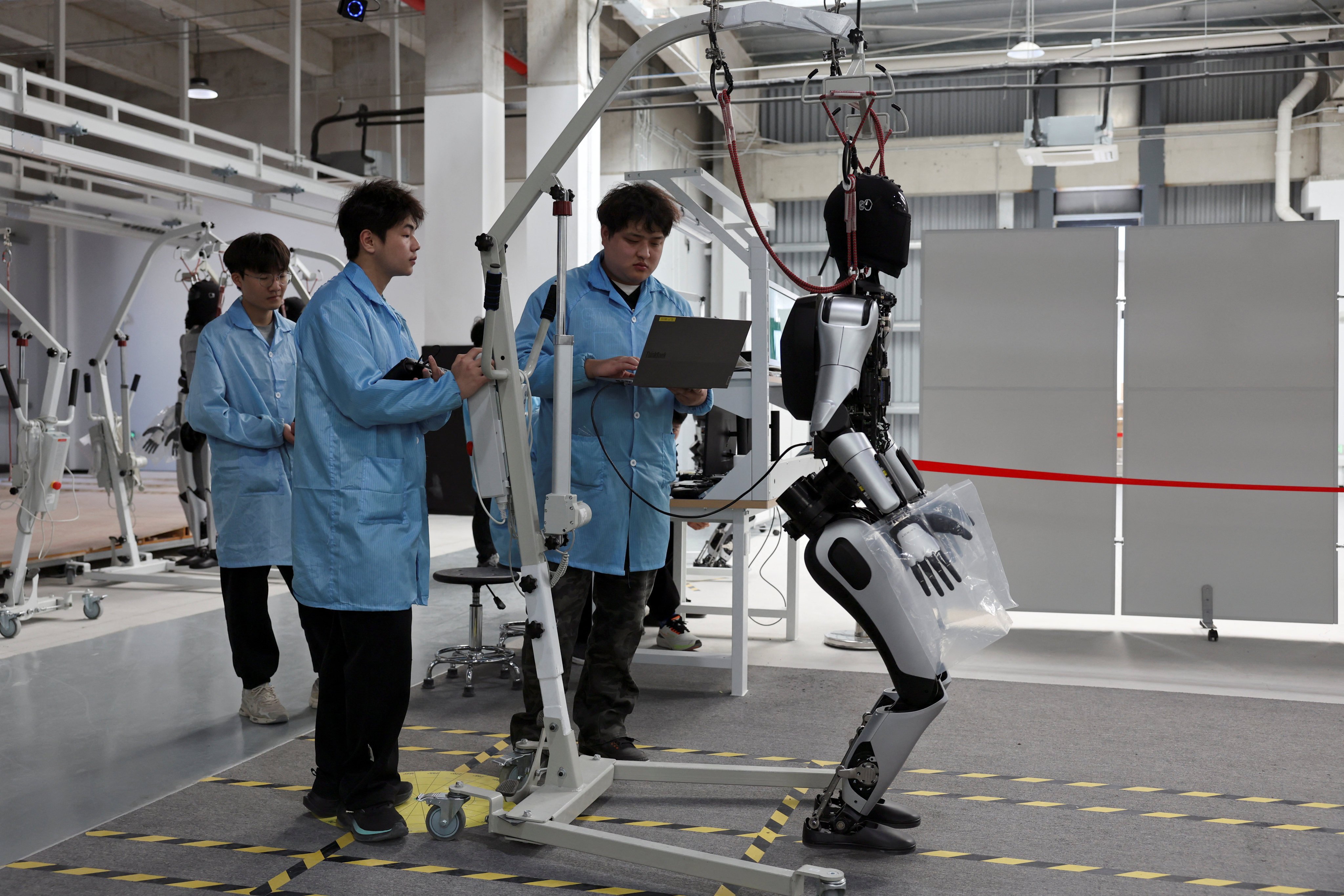 Employees work on a humanoid-robot production line at the AgiBot factory in Shanghai, China. Photo: Reuters