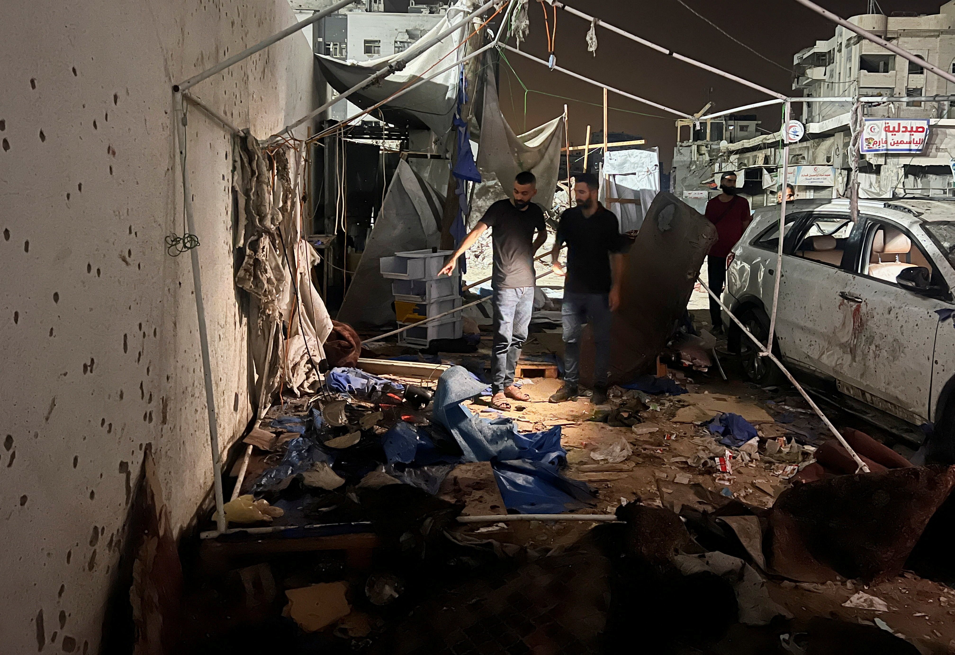 Palestinians inspect the site of an Israeli strike where Al Jazeera says its journalists were killed, in Gaza City on Sunday. Photo: Reuters