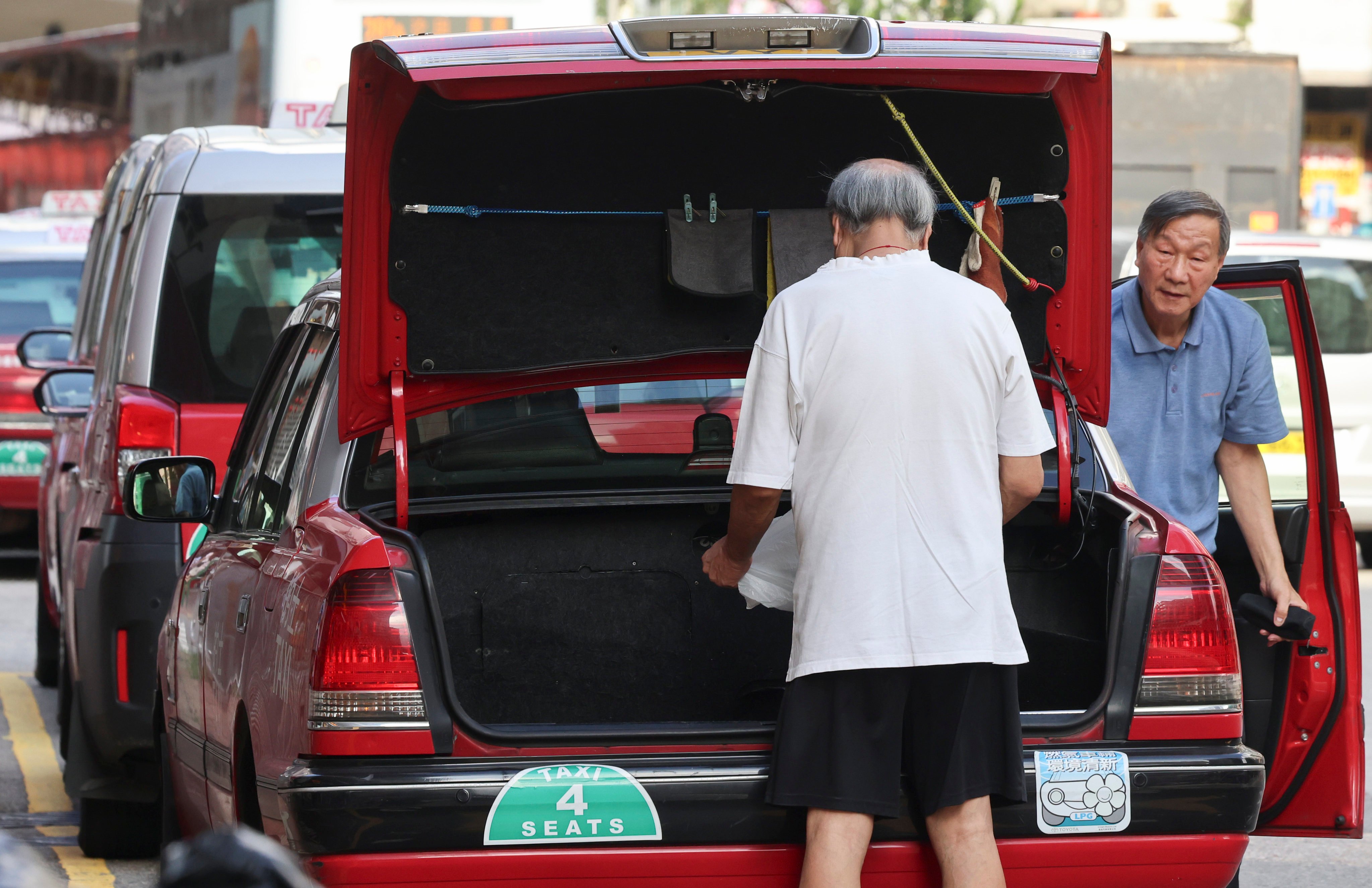 Elderly taxi drivers clean their vehicles at a depot in Prince Edward. Photo: Jelly Tse