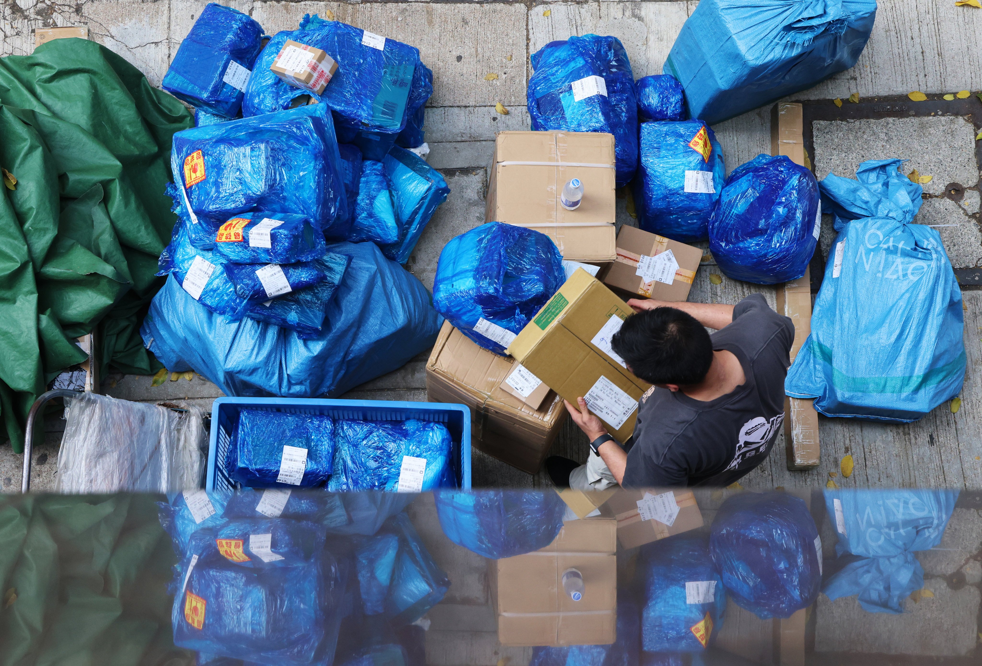 A courier worker sorts parcels in Wan Chai. Photo: Jelly Tse
