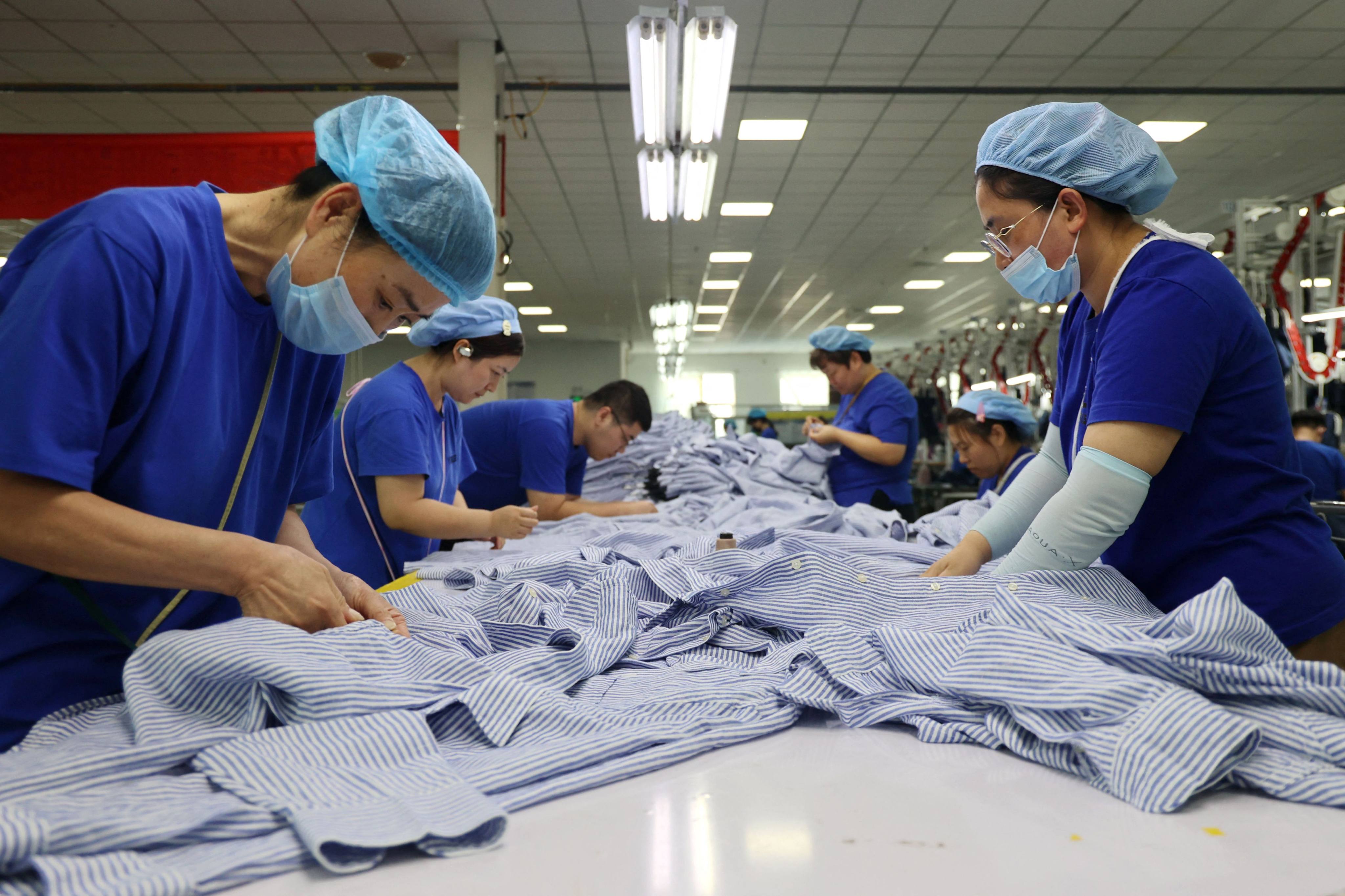 Employees work at a clothing factory in Shandong province in eastern China on July 17. Photo: AFP