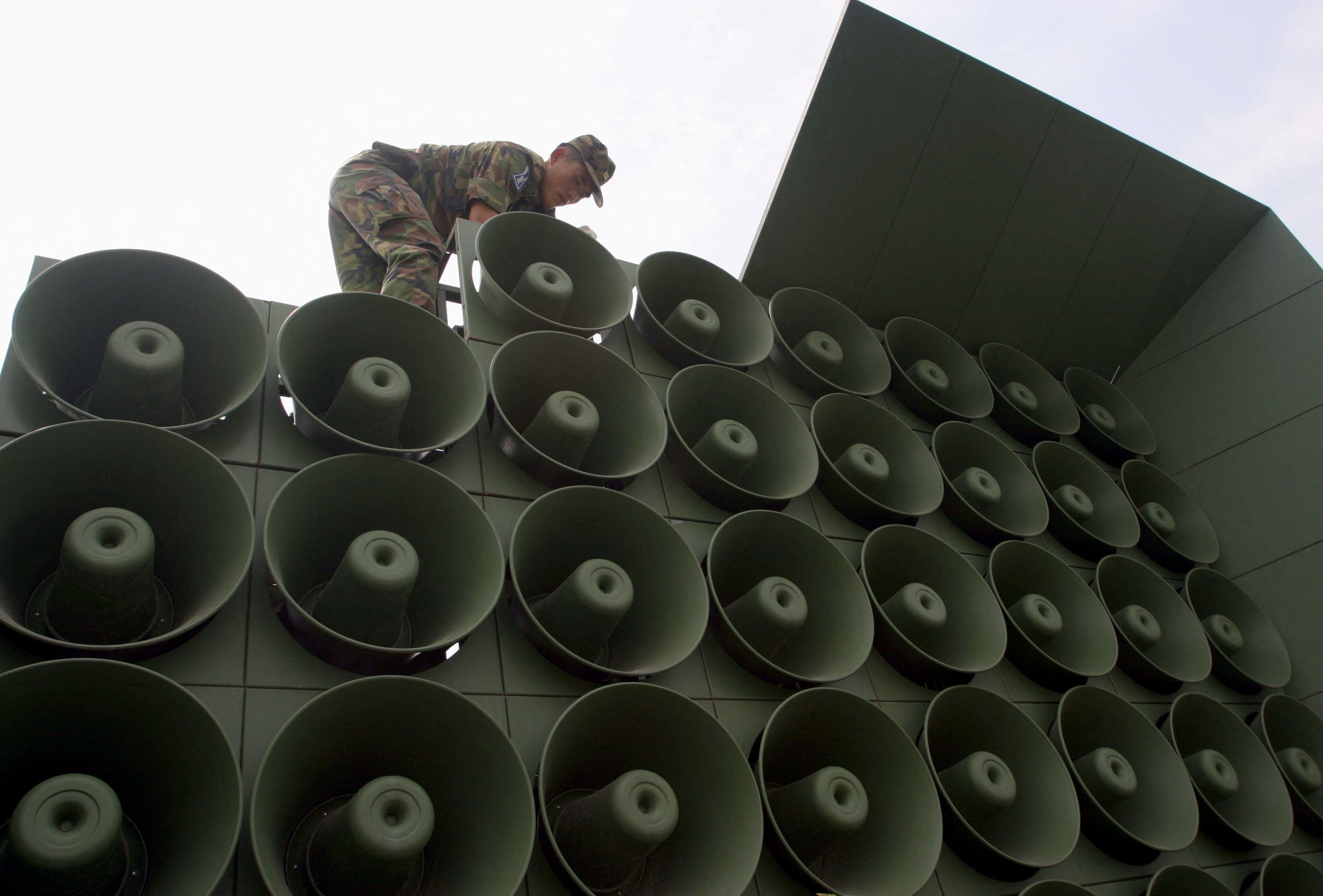 A South Korean soldier removes propaganda loudspeakers. Photo: Reuters
