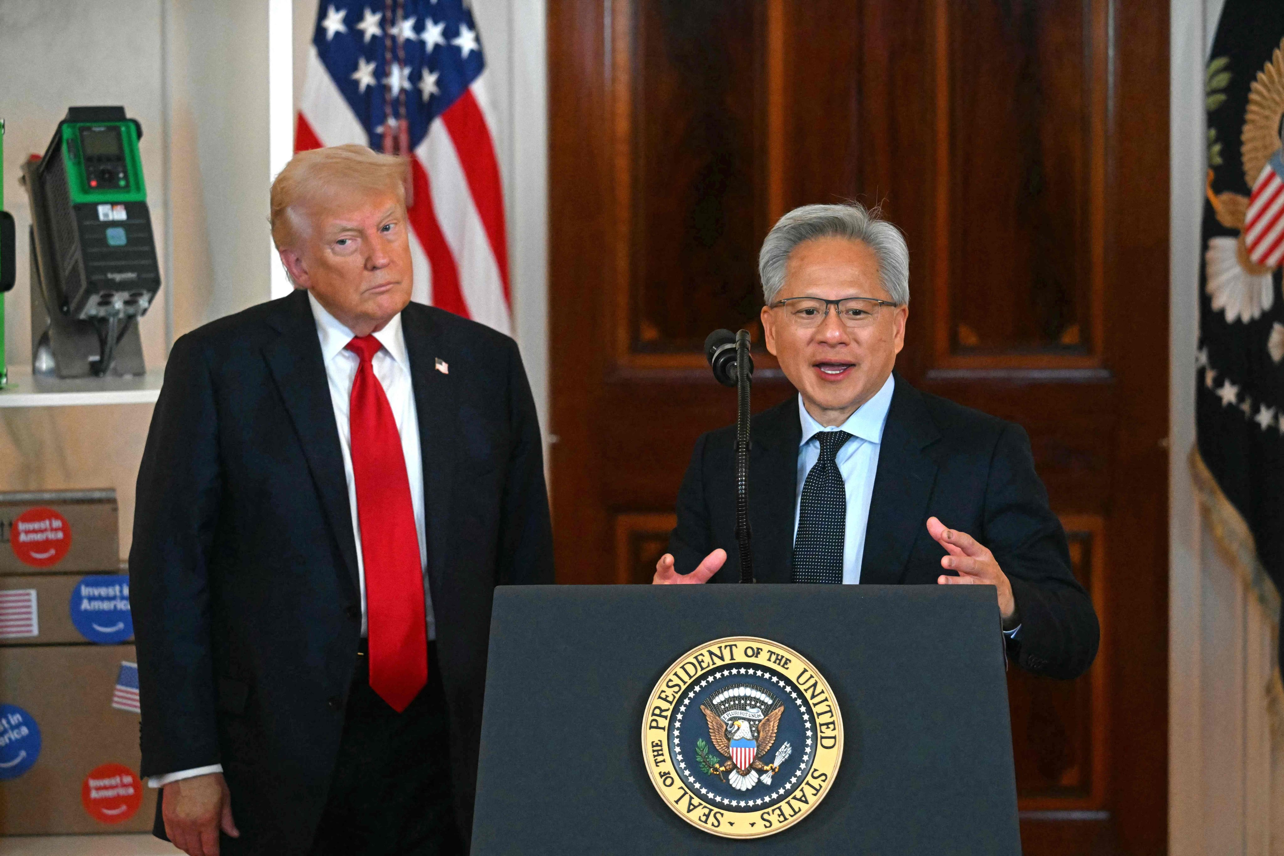 Nvidia CEO Jensen Huang (right) speaks alongside US President Donald Trump at the White House in April. Nvidia has agreed to pay 15 per cent of the revenue from sales of its H20 chip in China to the US government under a deal that analysts have called “unprecedented”. Photo: AFP