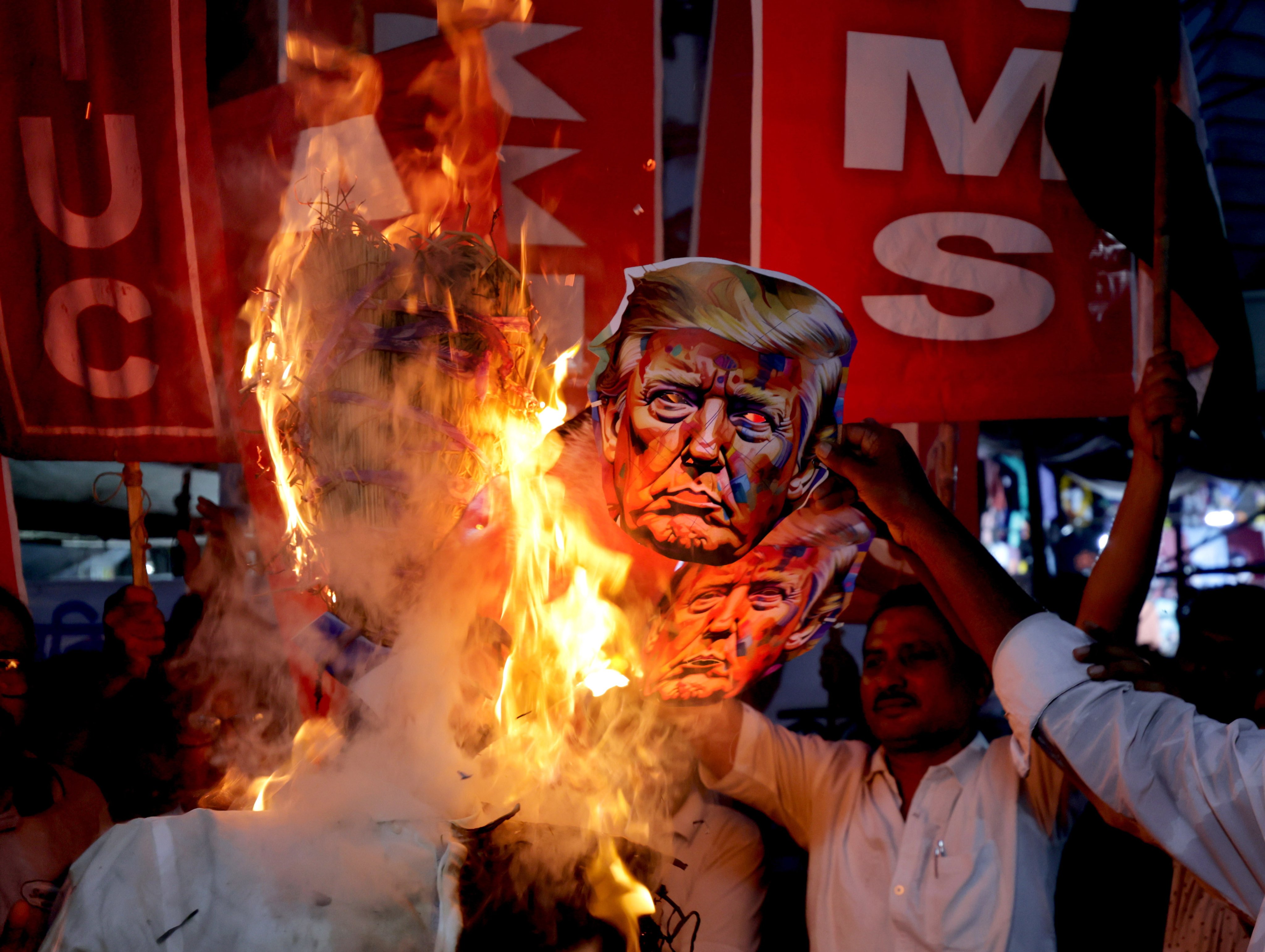 Activists protest against US President Donald Trump and his trade policies for India outside the US embassy in Kolkata on August 13. In an escalation of trade tensions between the United States and India, Trump announced additional tariffs of 25 per cent on Indian goods which would bring the total to 50 per cent. Photo: EPA