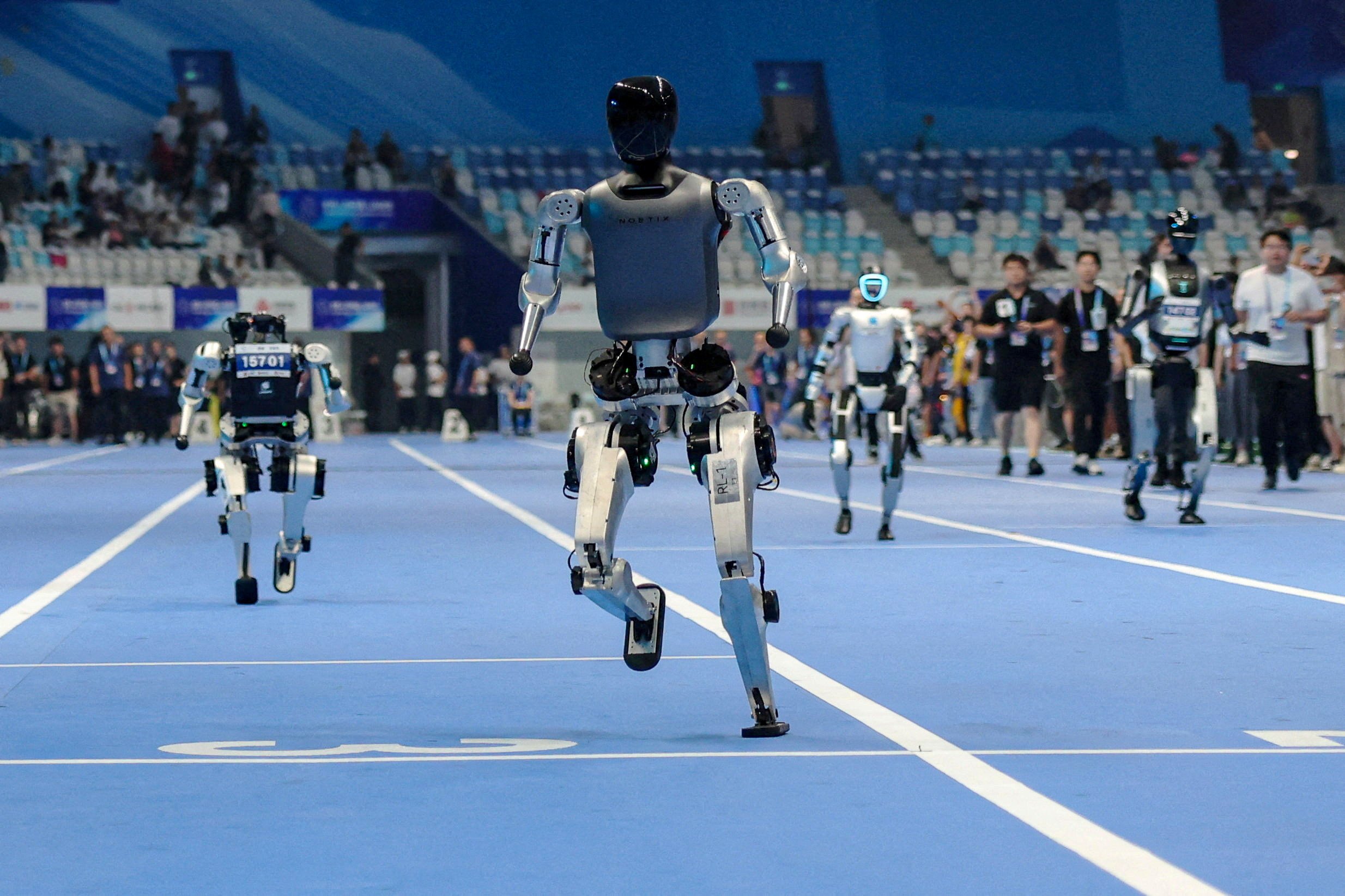 Humanoid robots take part in a test 100 metre run ahead of the World Humanoid Robot Games in Beijing on Thursday. Photo: Reuters