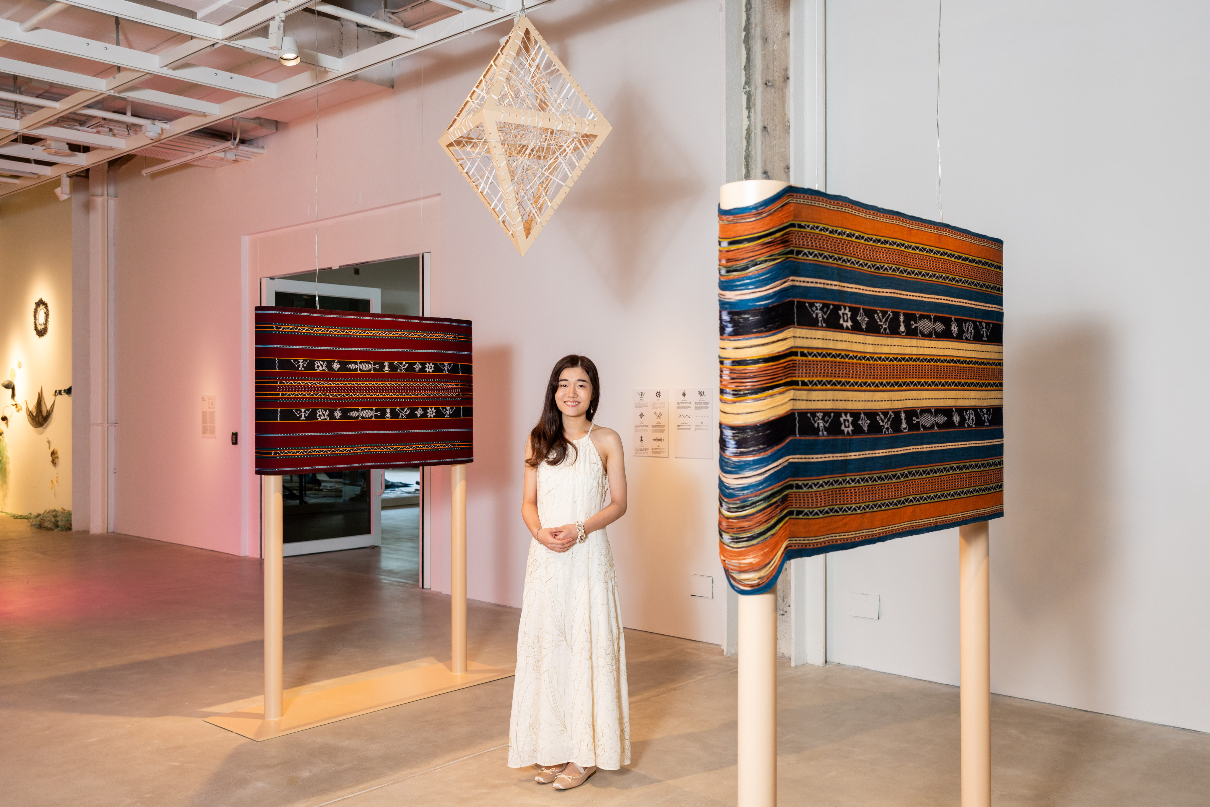 Hong Kong artist Mandy Ma stands with her hand-woven work Where Moments Gather (2025) at an exhibition at the Centre for Heritage, Arts and Textile in Tsuen Wan. Ma is one of a group of artists whose work highlighting traditional crafts is being showcased at the exhibition. Photo: courtesy of Chat