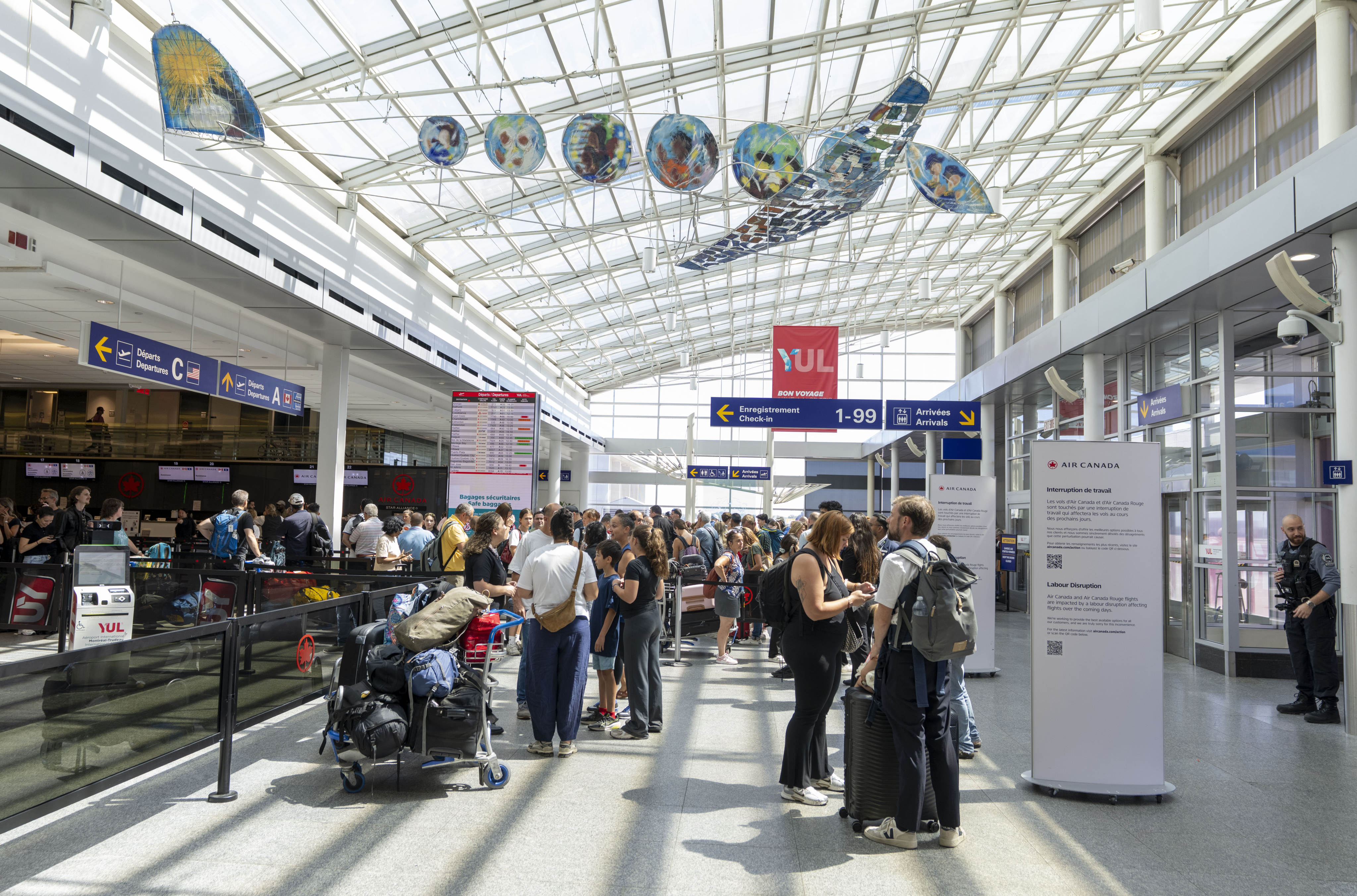 Travellers wait in line at the Air Canada counter in Montreal-Pierre Elliott Trudeau International Airport in Dorval, Quebec, on August 15. Photo: The Canadian Press via AP