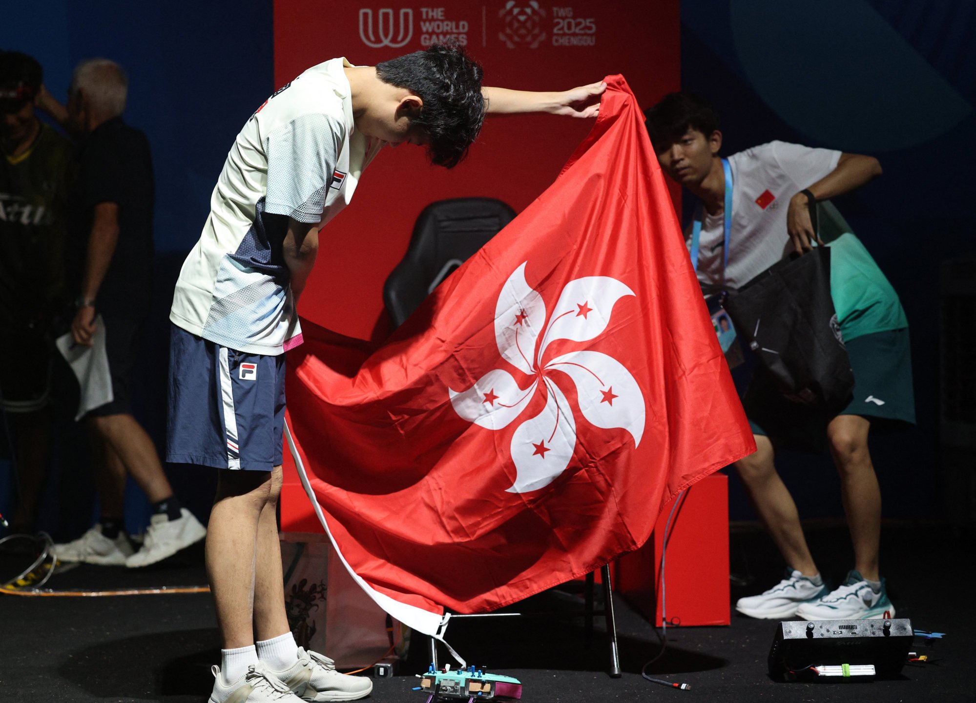 Kwan Chun-yan with the Hong Kong flag after his silver medal finish. Photo: Reuters