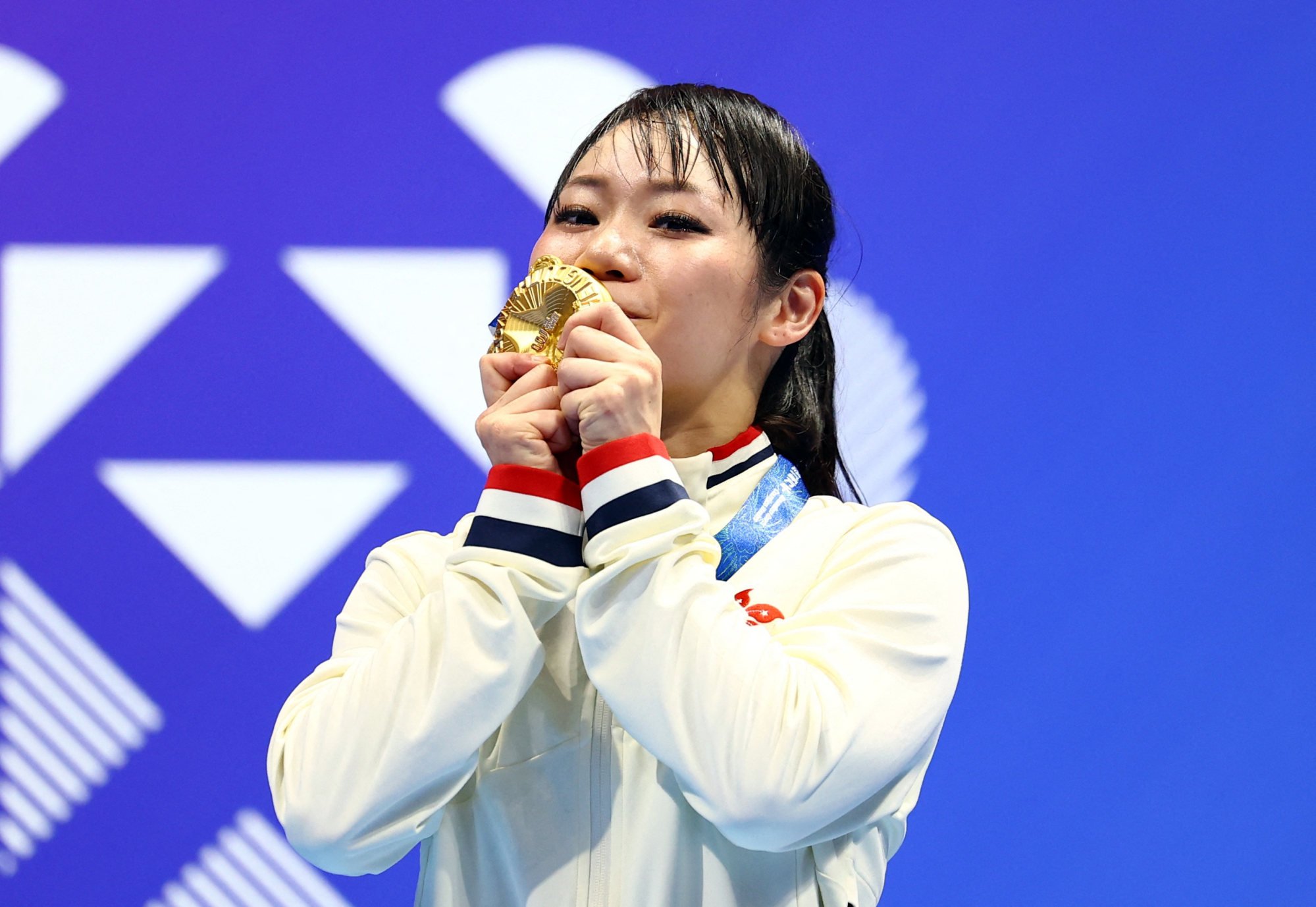 Hong Kong's Grace Lau savours winning her karate gold. Photo: Reuters