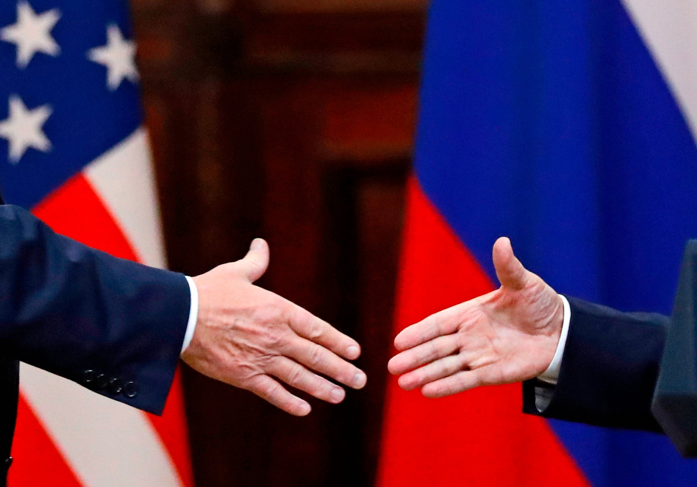 US President Donald Trump and Russian President Vladimir Putin go to shake hands at the end of a press conference in 2018. Photo: AP