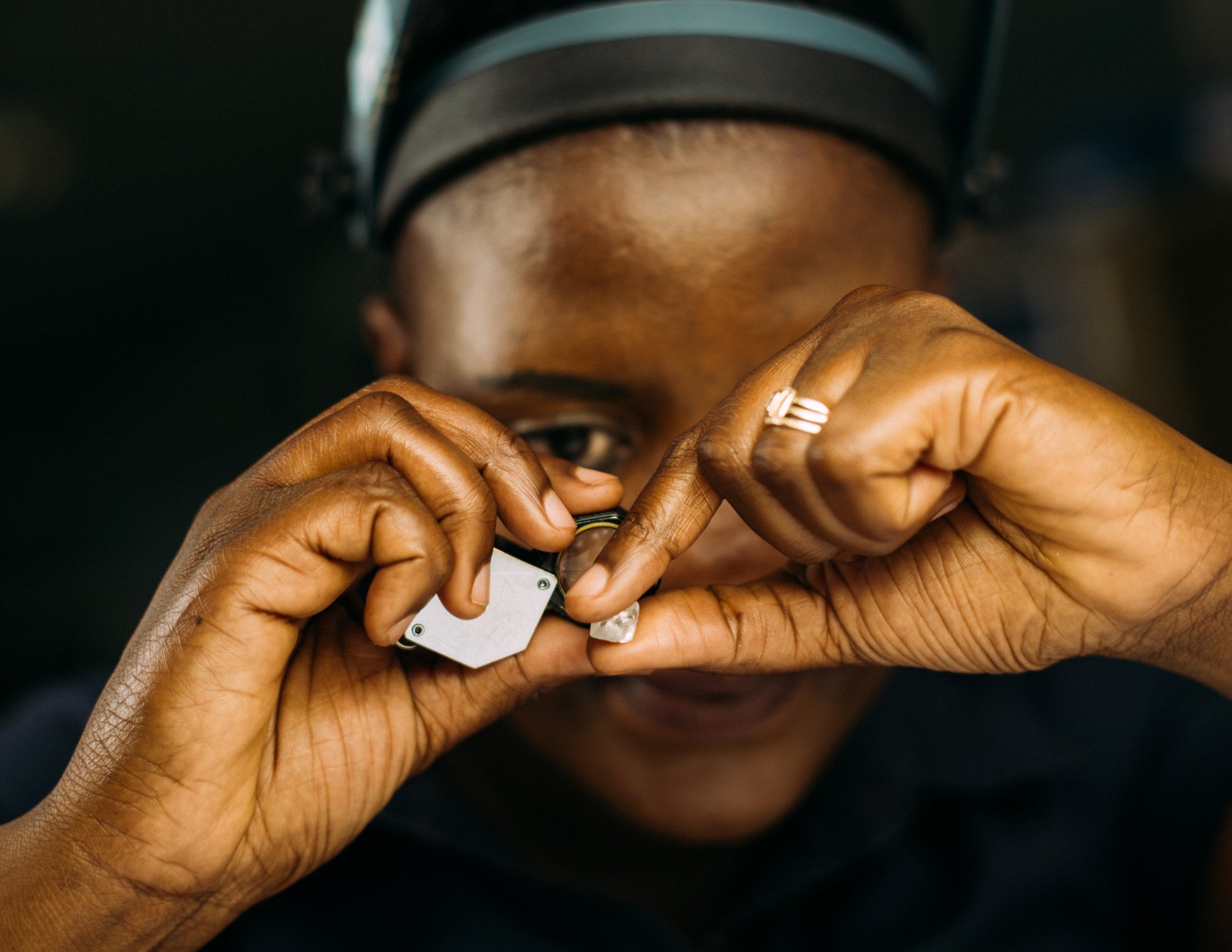 A De Beers employee in Botswana sorts through rough diamonds with a loupe. Photo: Handout