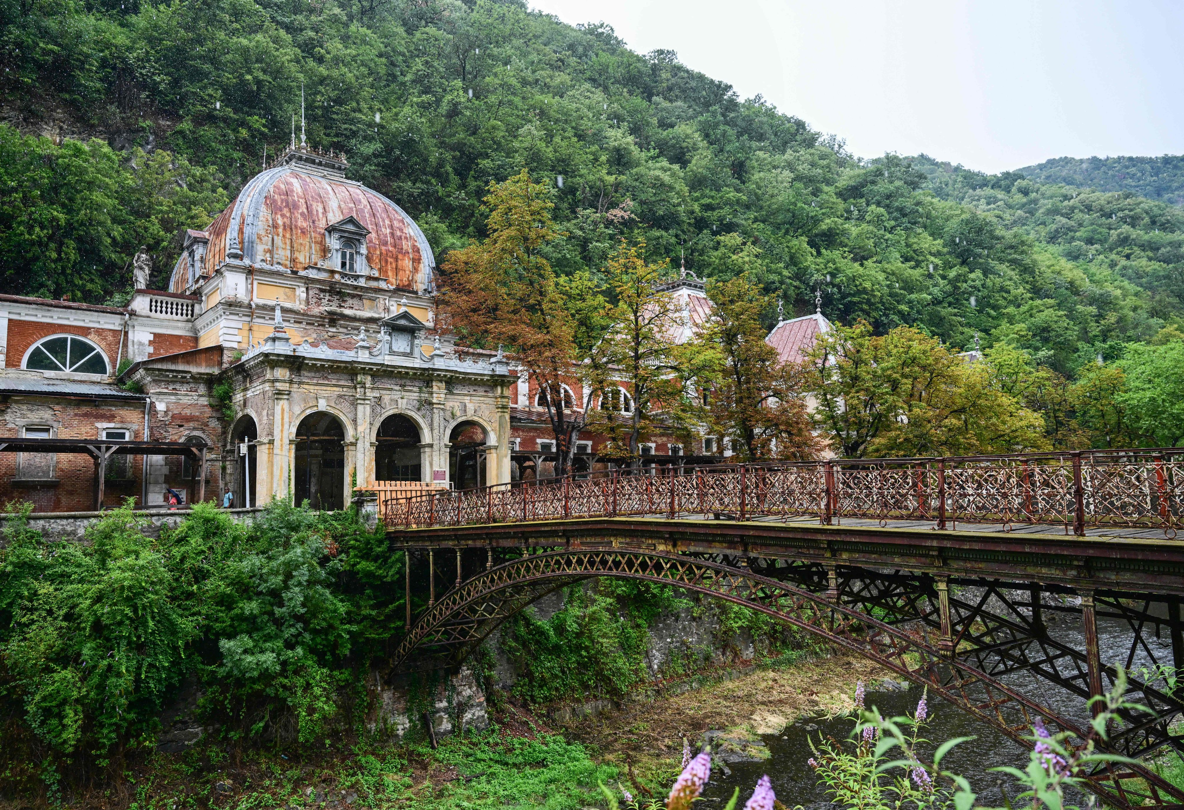 The Neptune Imperial Baths building and the wrought iron bridge that is closed for access in Baile Herculane, Romania, on July 29. Photo: AFP