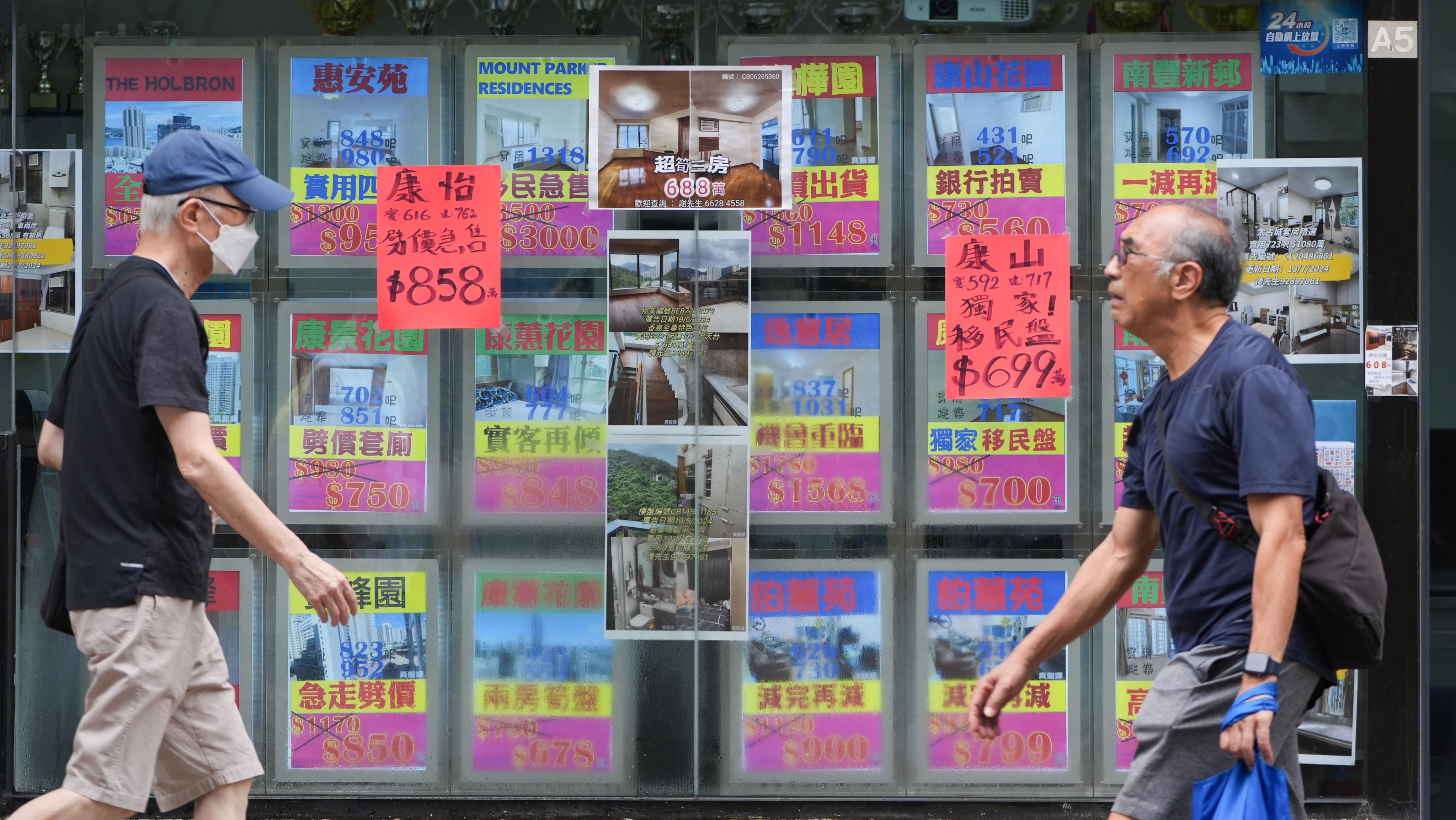 People walk past a property agency in Tai Koo on July 29, 2024. Home prices have stabilised since the start of this year after a nearly 30 per cent decline since the 2021 peak. Photo: Eugene Lee