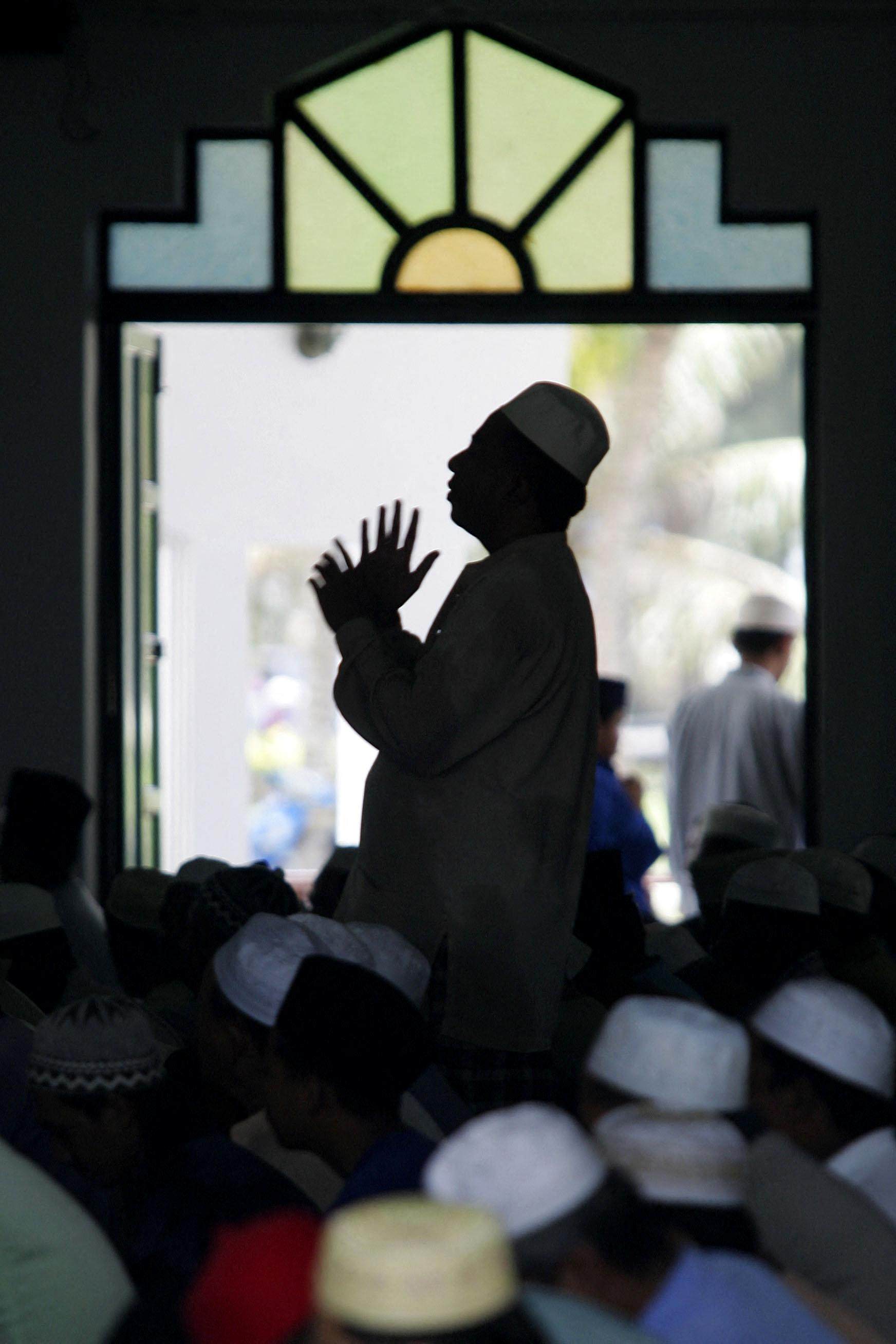 A Muslim man raises his hands in prayer at a mosque in Kuala Terengganu, the capital of Malaysia’s Terengganu state. Photo: AFP