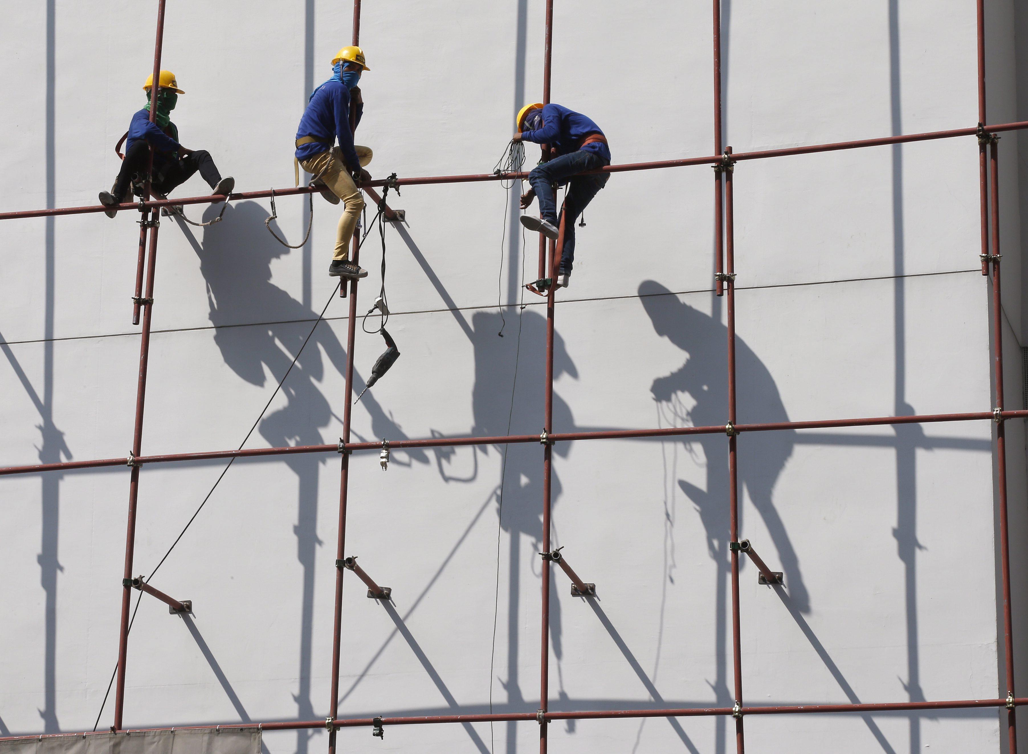 Thai workers on scaffolding at a building site in Bangkok. Thailand’s ageing population and shrinking workforce have forced it to rely on at least 3 million registered foreign labourers. Photo: EPA