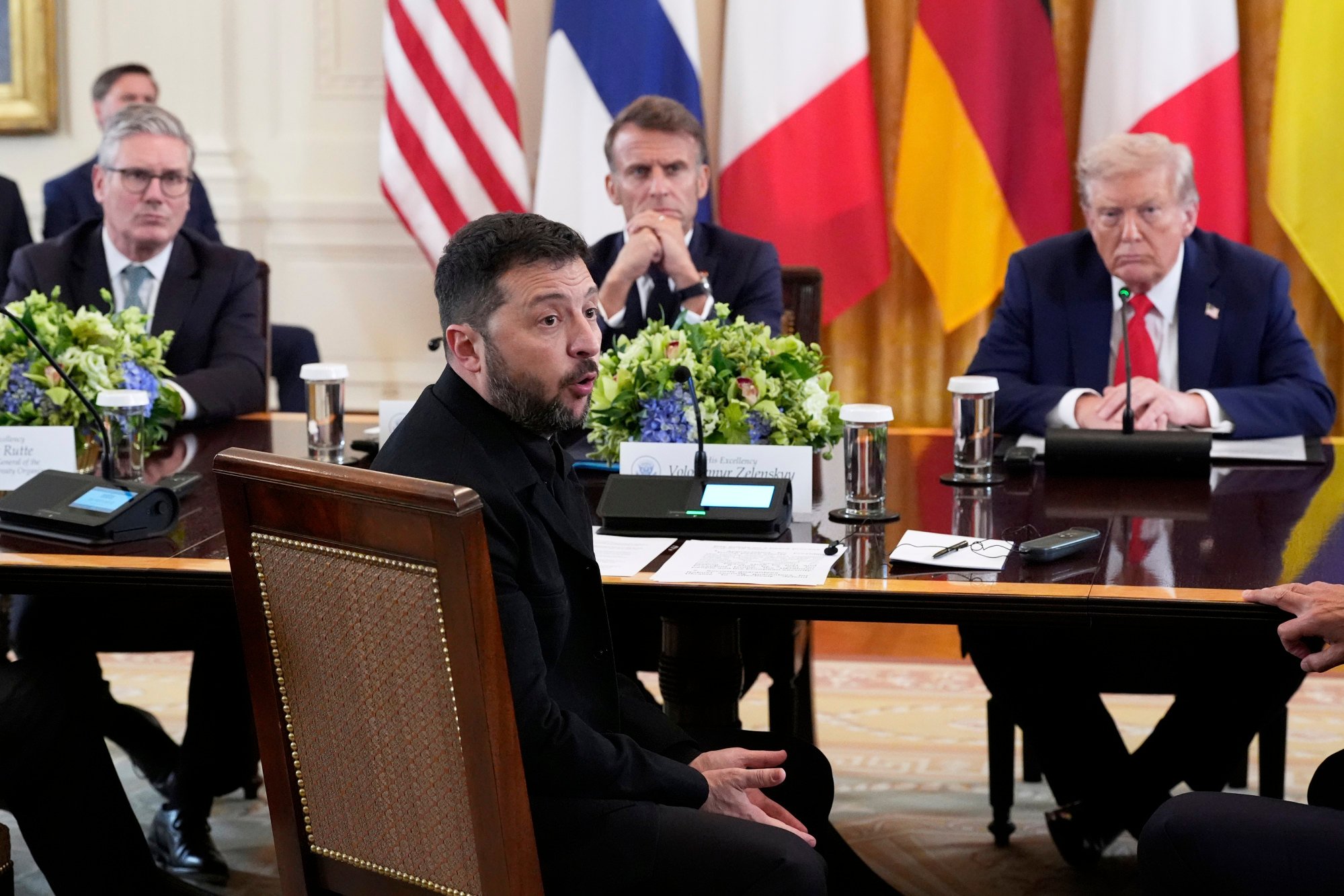 Ukraine’s President Volodymyr Zelensky speaks as British Prime Minister Keir Starmer, seated from background left, France’s President Emmanuel Macron and US President Trump listen during a meeting in the East Room of the White House, Monday. Photo: AP