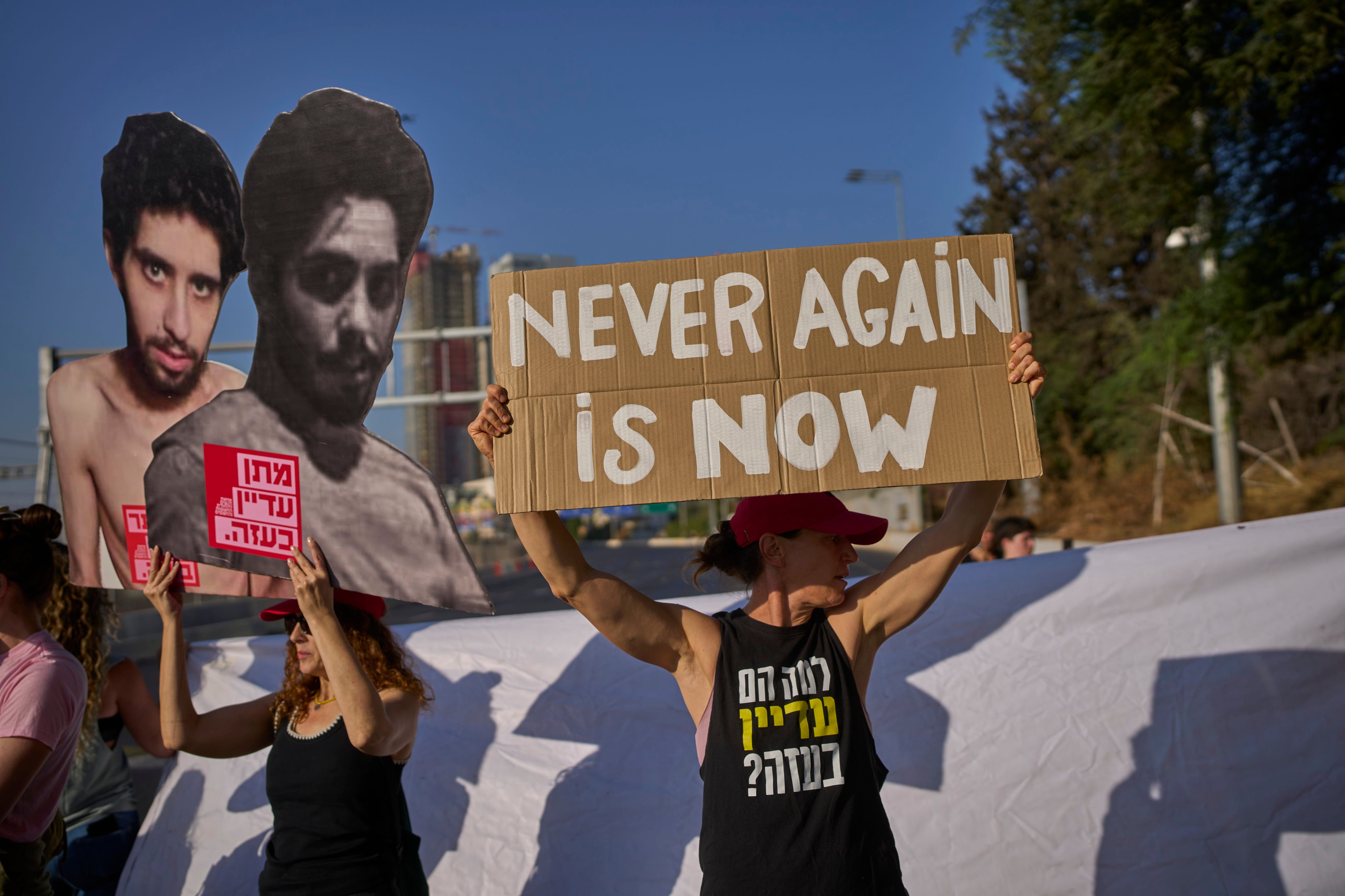 Demonstrators hold placards as they block a road during a protest demanding the immediate release of hostages held by Hamas and calling for the Israeli government to reverse its decision to take over Gaza City and other areas in the Gaza Strip, in Tel Aviv, Israel, on Tuesday. Photo: AP