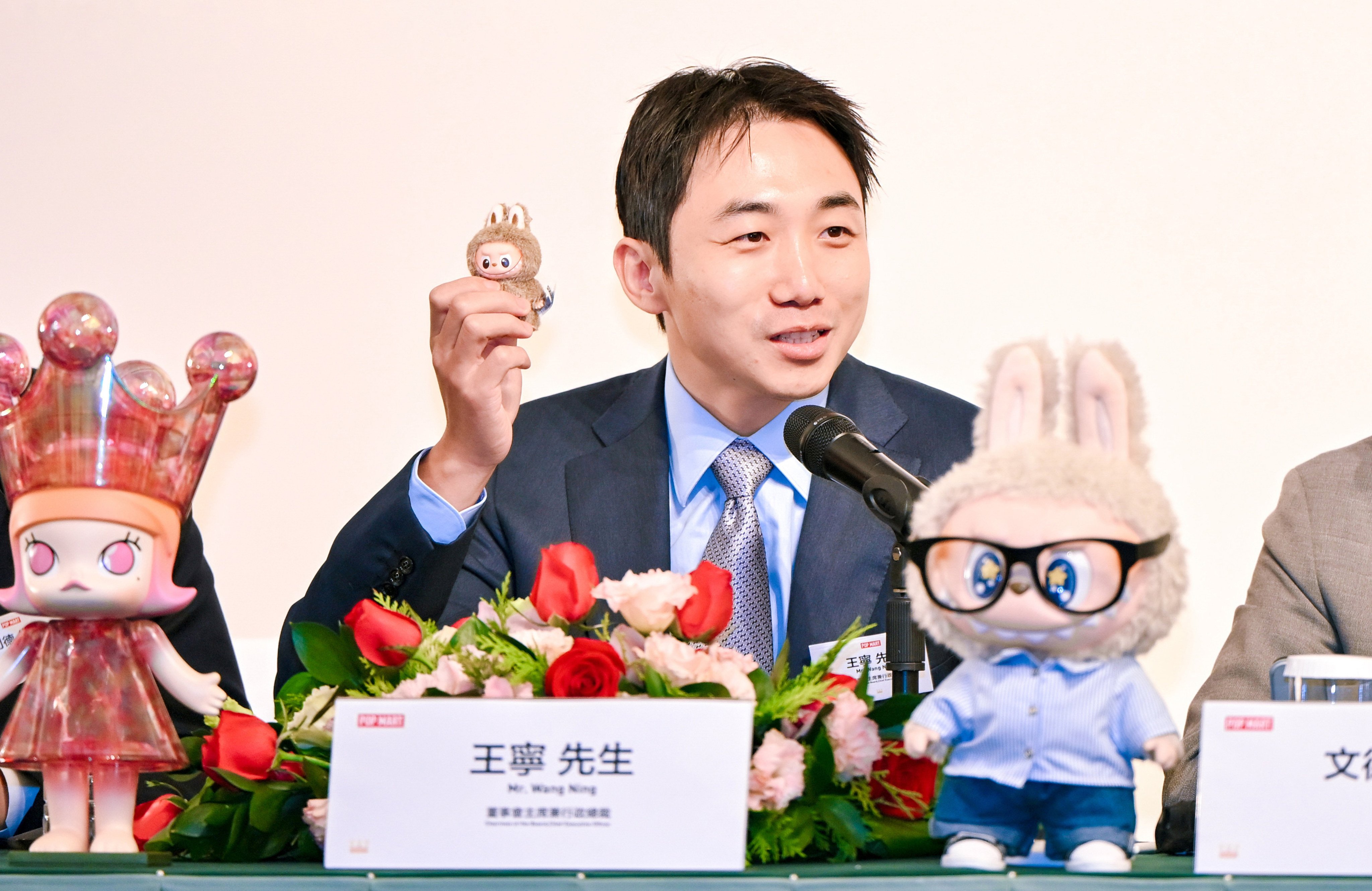 Pop Mart’s founder and CEO Wang Ning with a mini Labubu plush toy during the company’s post-earnings press conference in Hong Kong on Wednesday. Photo: Handout