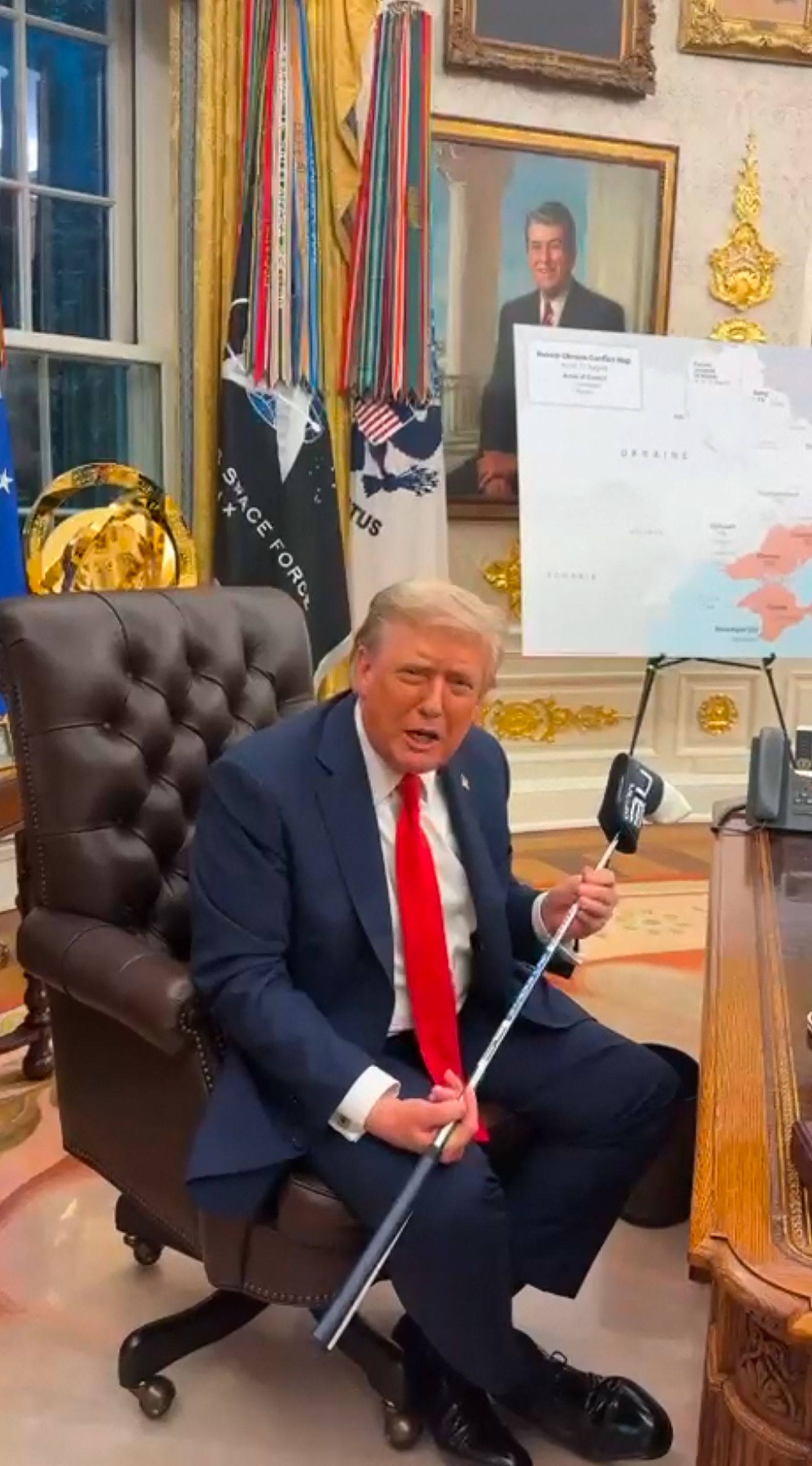 US President Donald Trump with a golf club presented to him by Ukrainian President Volodymyr Zelensky at the White House in Washington in an image grab taken from a video provided on Tuesday by the Ukrainian Presidential Office. Photo: Ukrainian Presidential Office / AFP / Handout