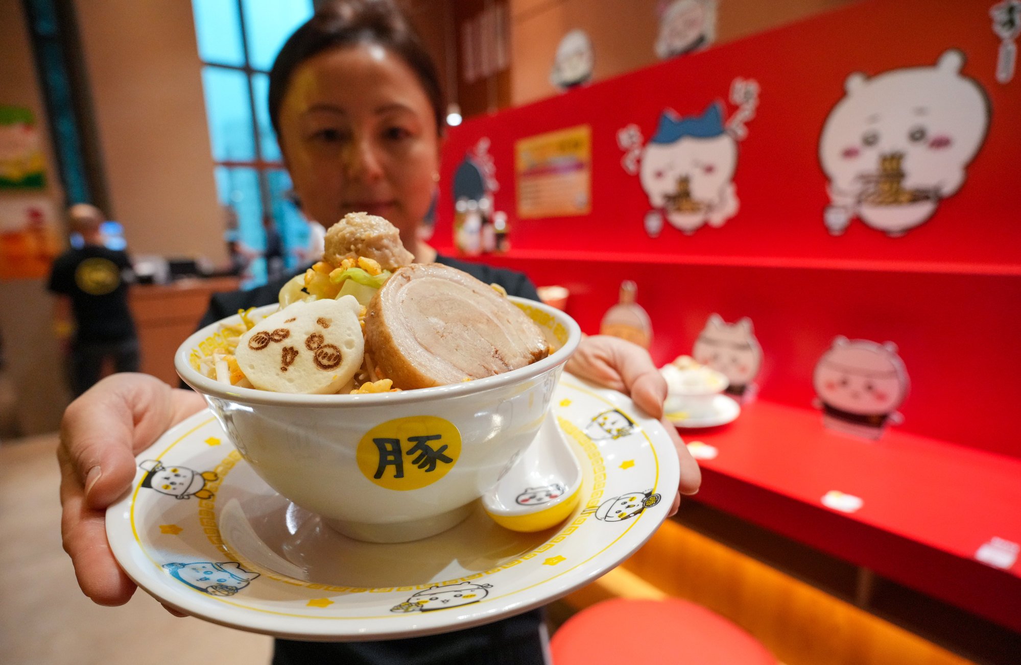 Staff member Grace Lu with a ramen dish at Chiikawa Ramen Buta in Langham Place. Photo: May Tse
