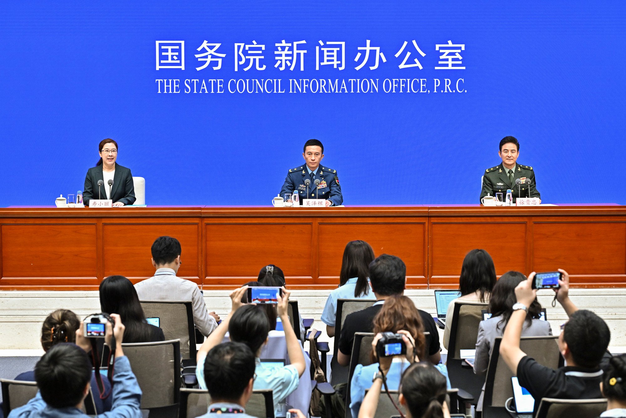 Wu Zeke, deputy head of the warfare bureau at the Central Military Commission's Joint Staff Department (centre), briefs reporters on preparations for the parade. Photo: Xinhua