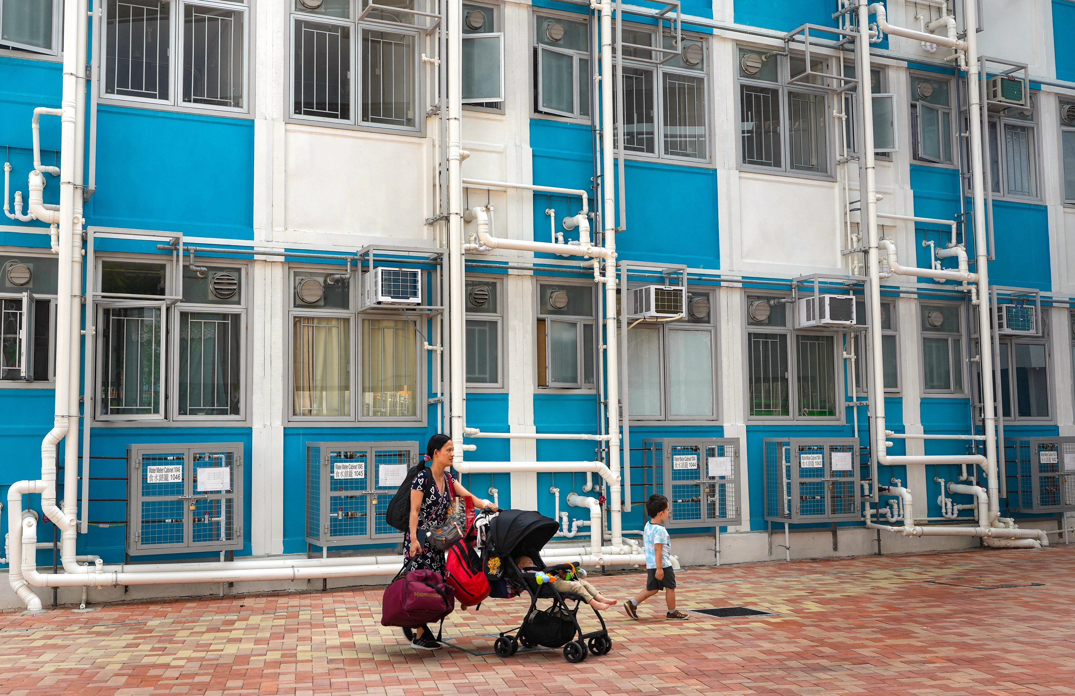 A woman and two children pass a transitional housing project in Kam Tin, Yuen Long. Photo: Elson Li