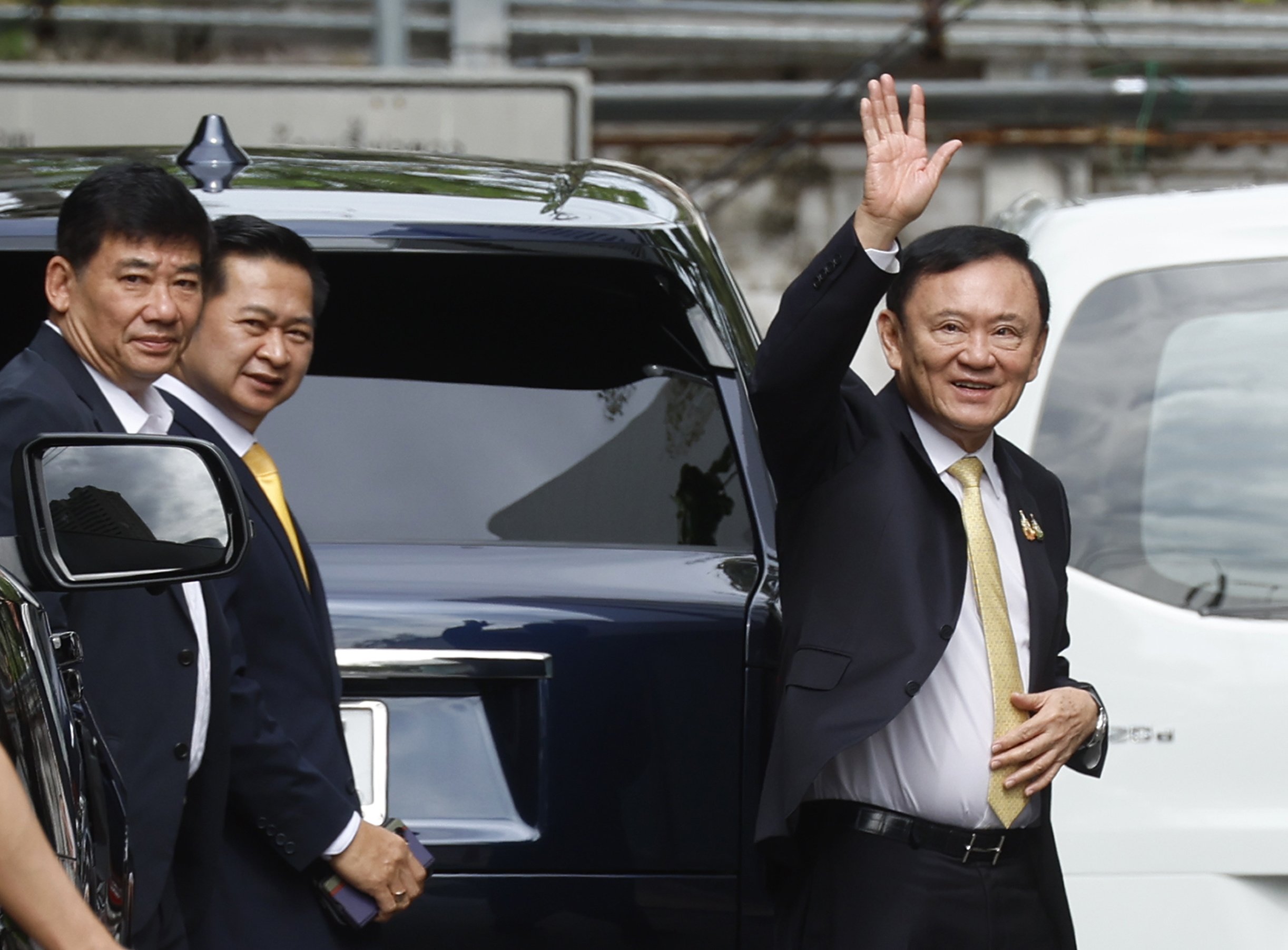 Former Thai Prime Minister Thaksin Shinawatra waves after arriving at the Criminal Court to hear the court’s decision on charges of insulting the monarchy, in Bangkok, Thailand on Friday. Photo: EPA