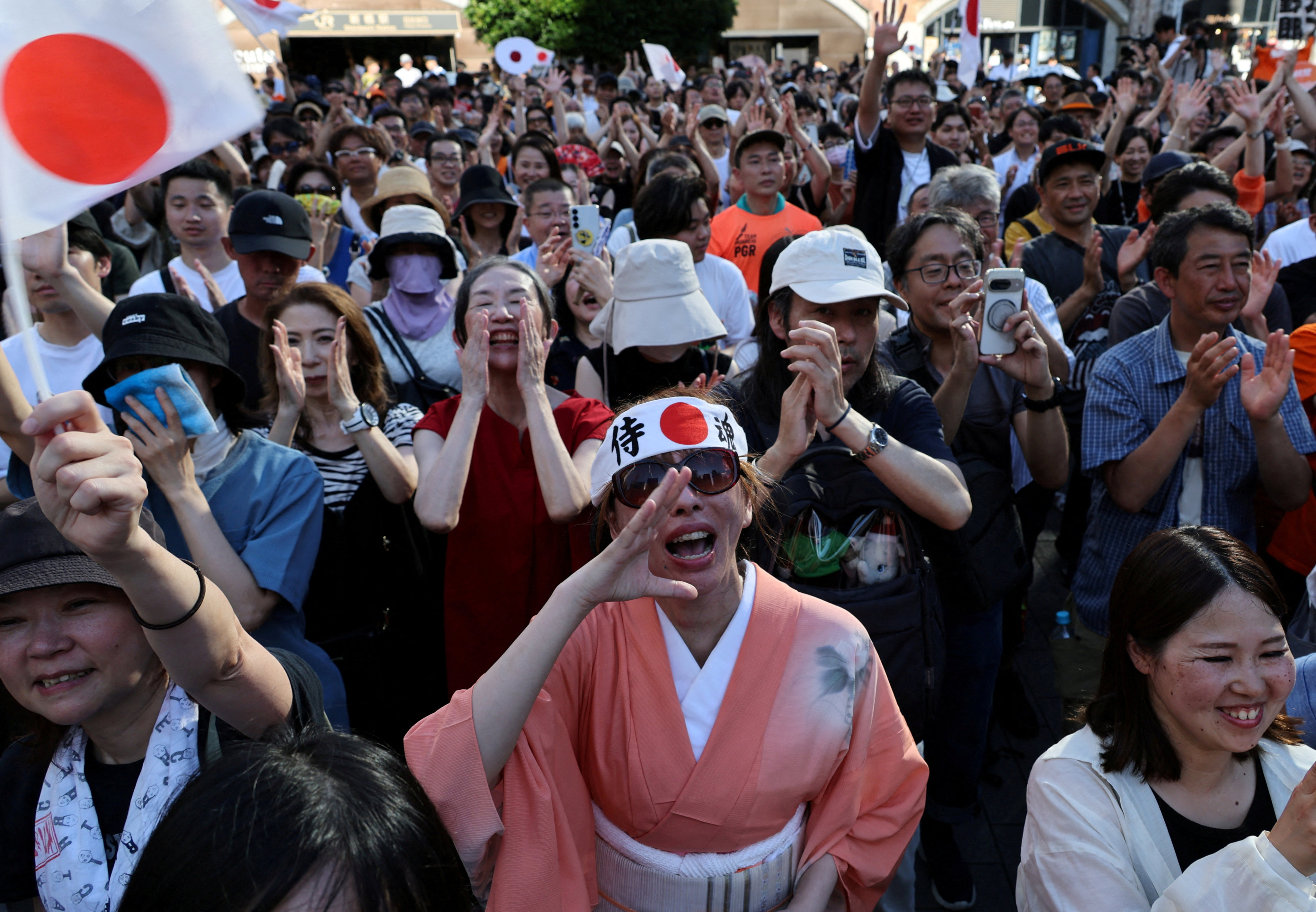 Supporters of Japan’s Sanseito, a far-right party with an anti-foreigner agenda, react during a rally in Tokyo on July 21. Photo: Reuters