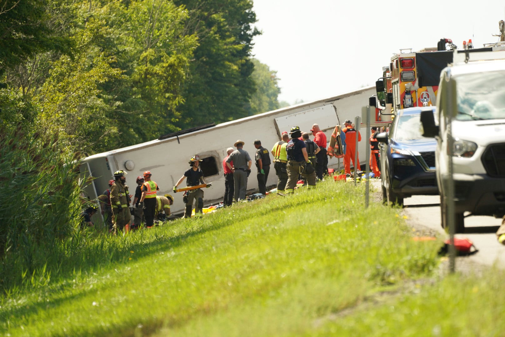 First responders work to rescue victims at the scene of a tour bus that crashed and rolled over on the New York State Thruway near Pembroke, New York, on Friday. Photo: Buffalo News via AP