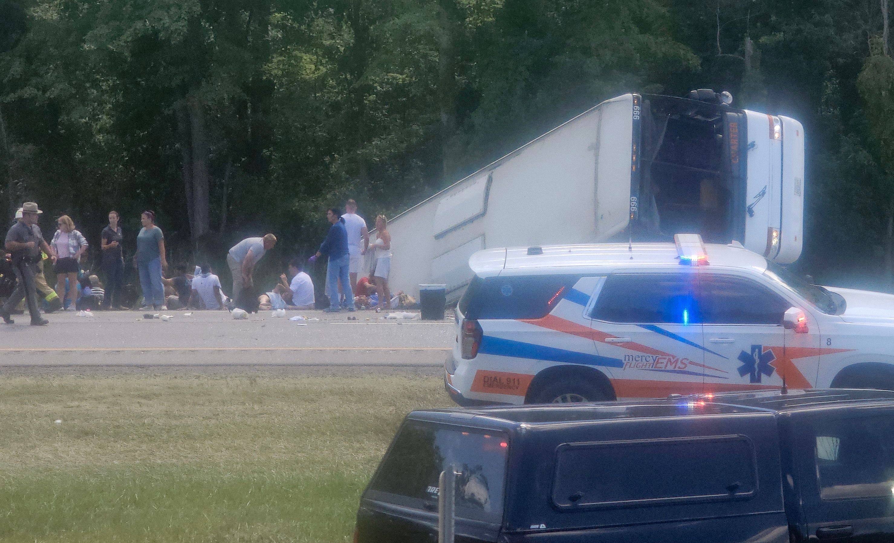 Victims and emergency personnel are seen at the site of a bus crash near Pembroke, New York, on Friday. Photo: by Mike Flaig/Facebook via AFP