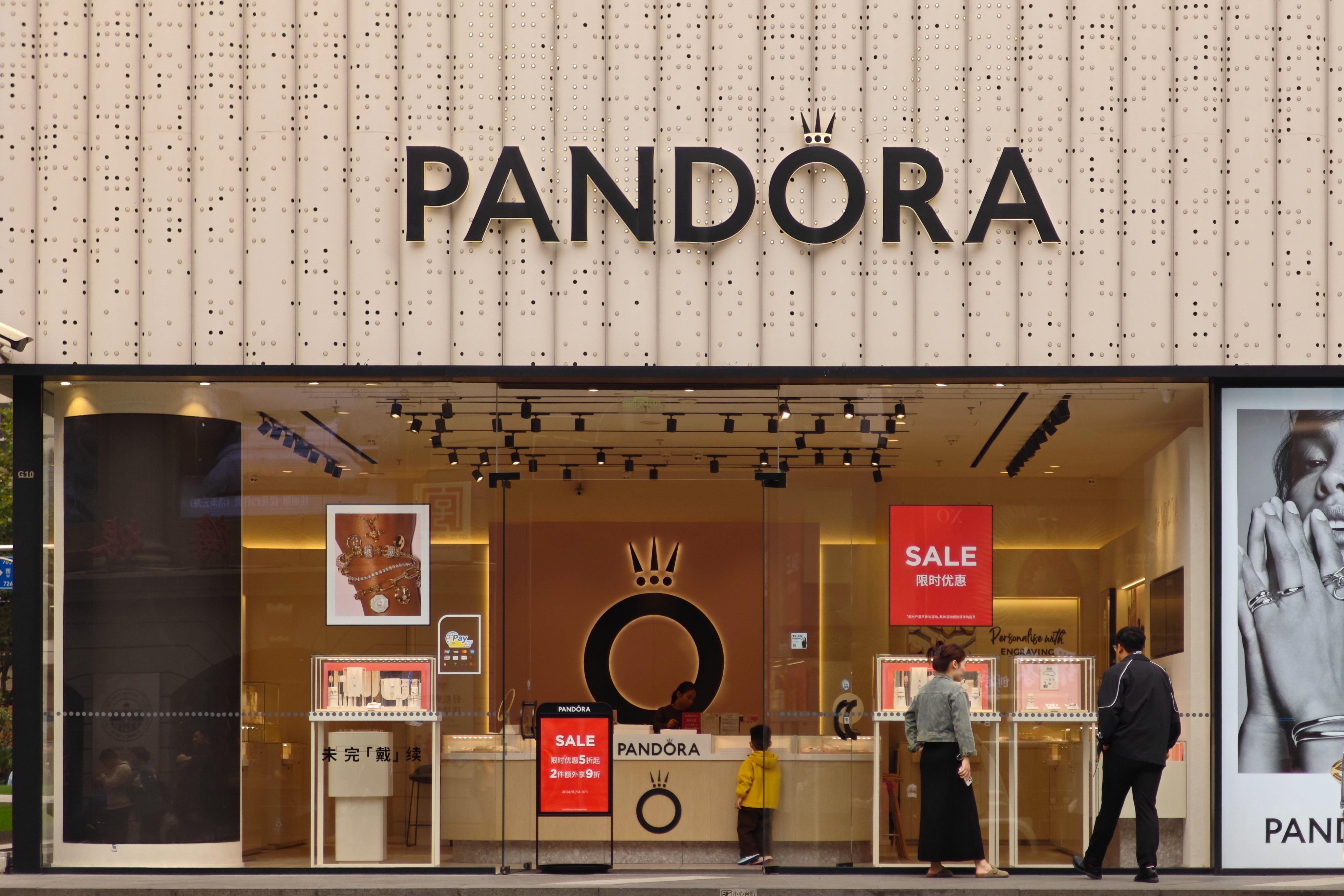 Pedestrians are seen at a Pandora store in Shanghai. Pandora’s annual sales in China peaked in 2019 and have steadily declined in recent years. Photo: Getty Images