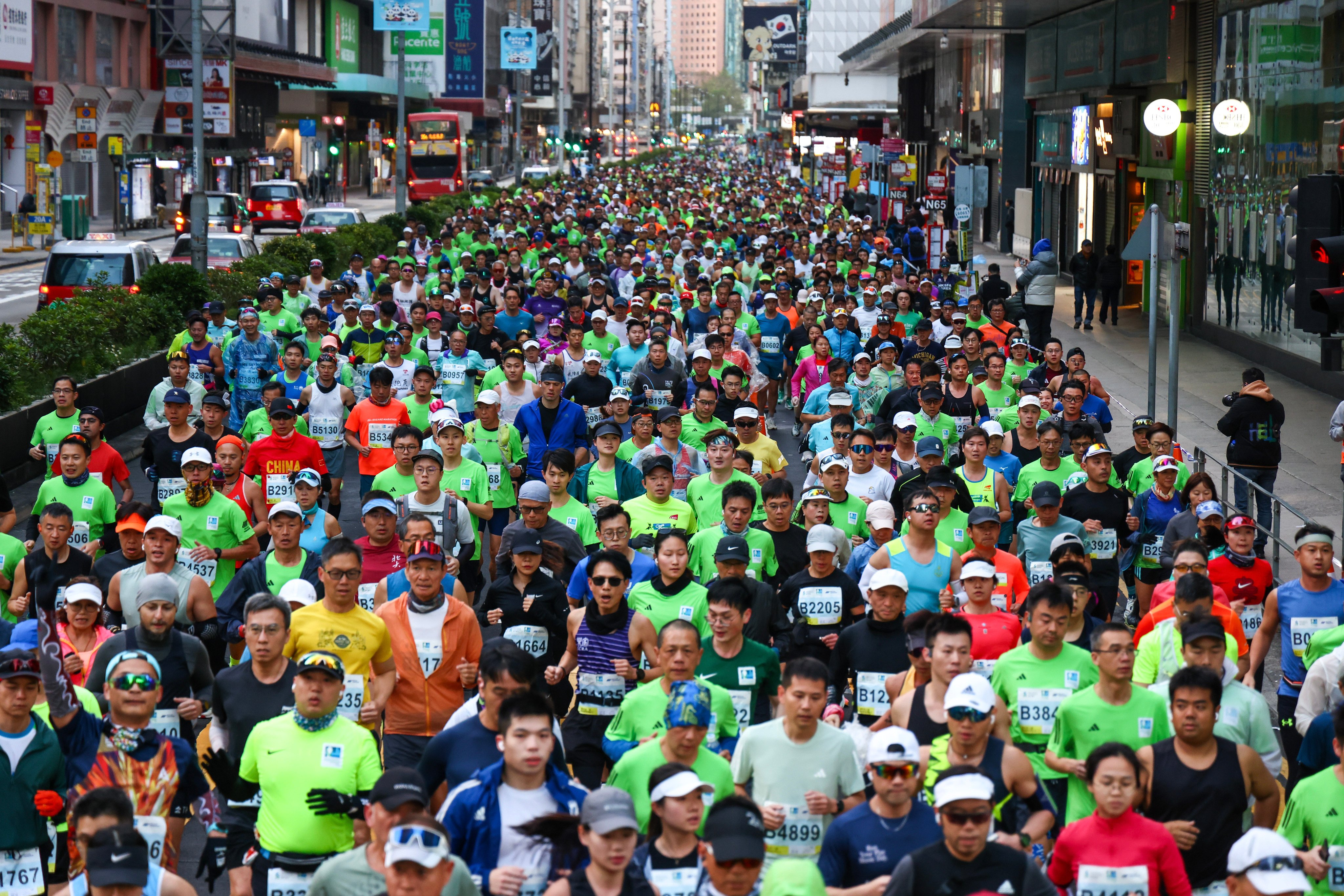 Runners pass through Mong Kok during the 2025 Standard Chartered Hong Kong Marathon. Photo: Dickson Lee