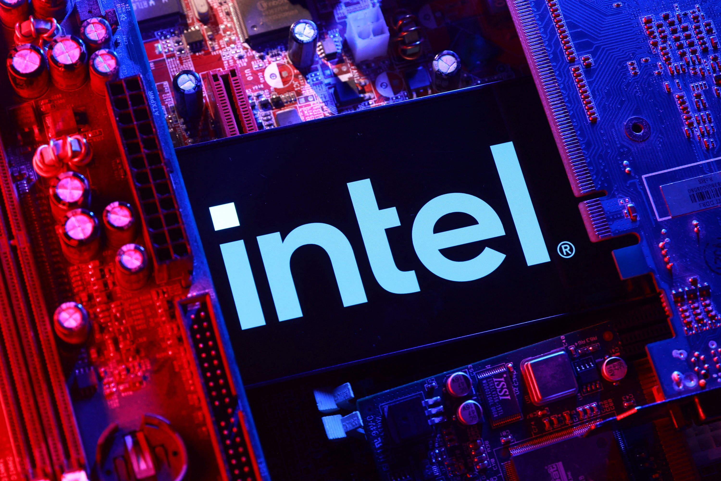 An Intel logo and a computer motherboard. Photo: Reuters