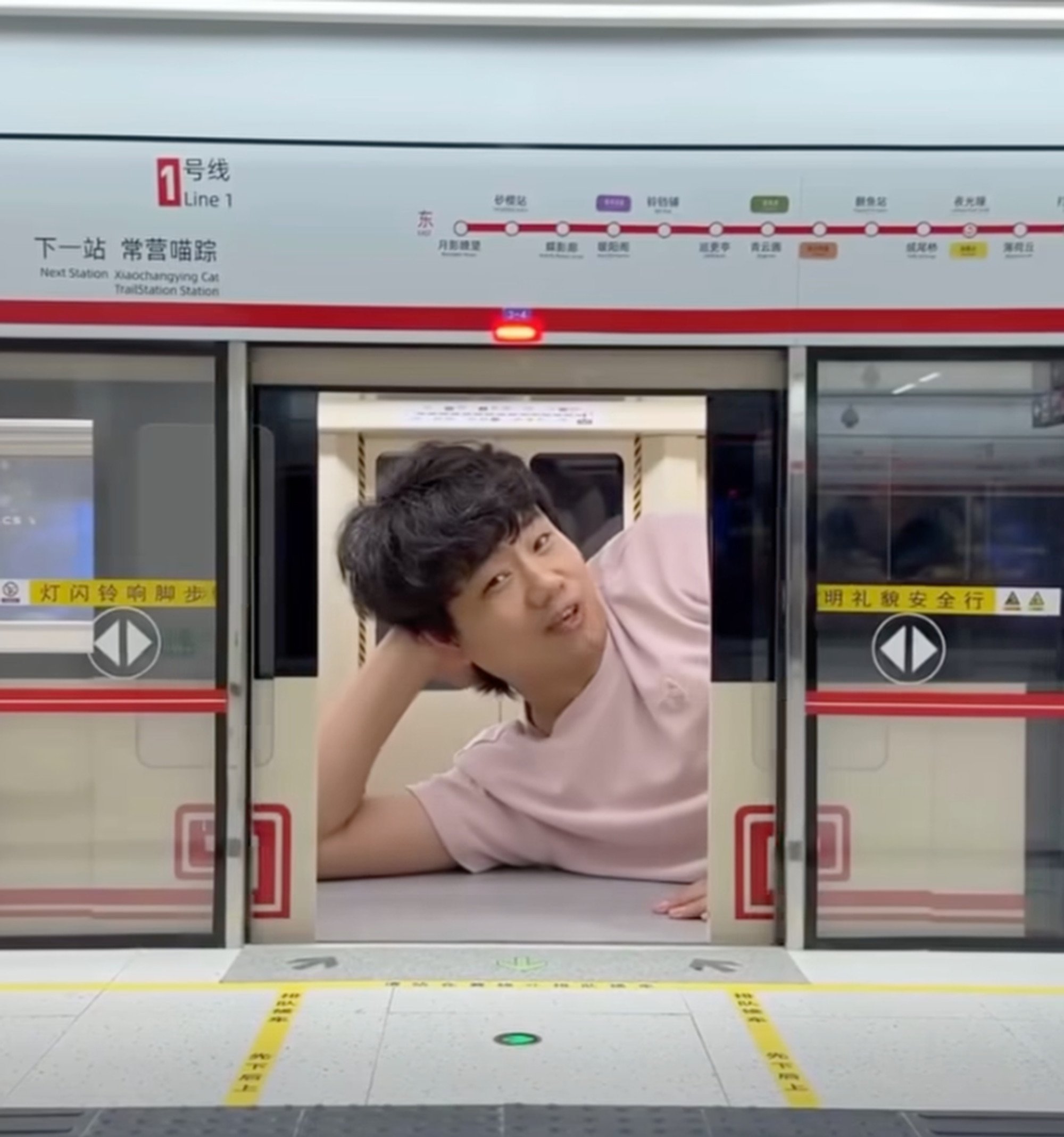 Xing Zhilei relaxes inside a train carriage he made as part of the cat station project. Photo: Facebook