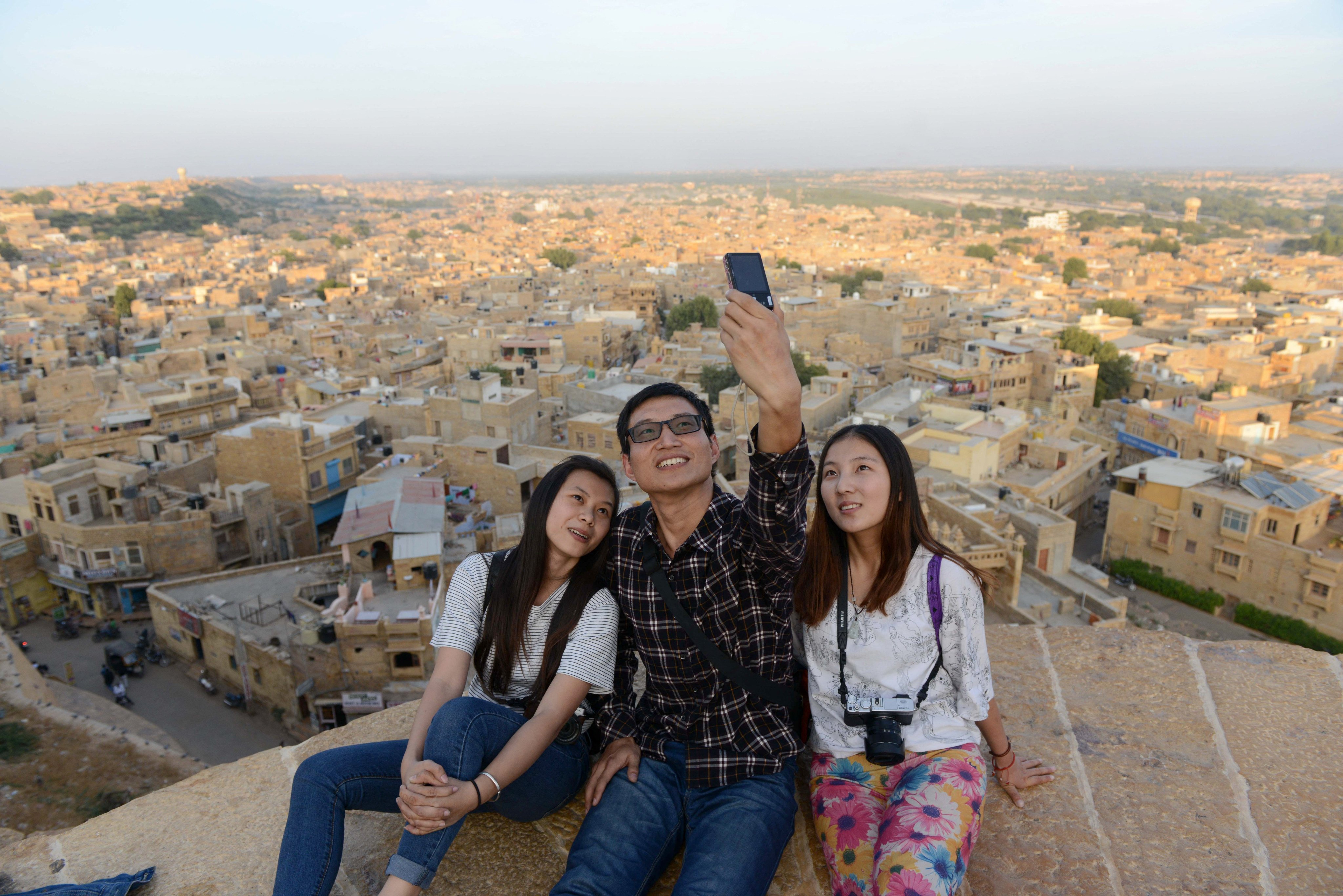Chinese tourists take a selfie photograph at the ancient Golden Fort of Jaisalmer on Trikuta Hill in the state of Rajasthan, India. Photo: AFP