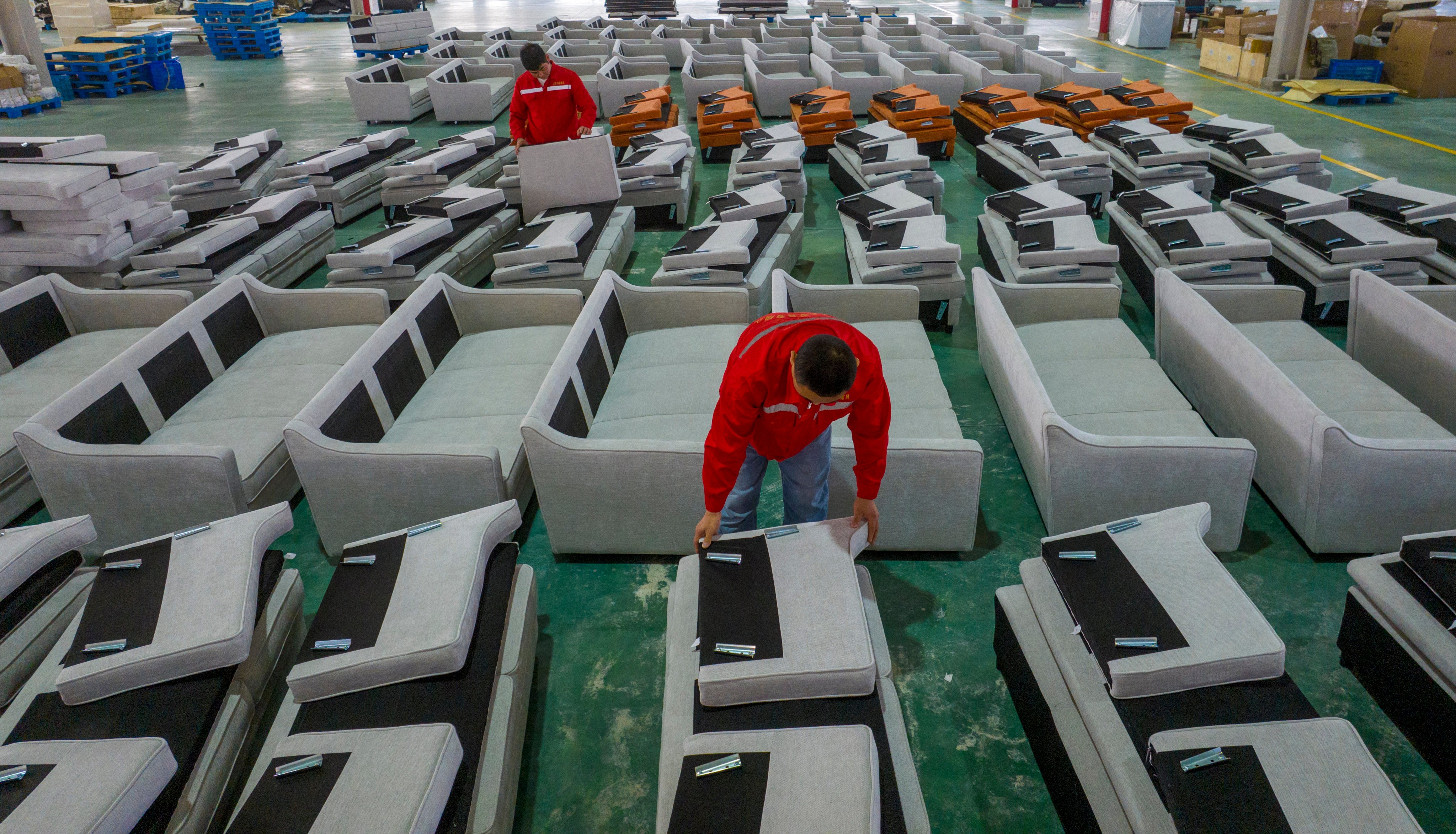 Workers produce sofas for sale to Europe and the United States at a furniture workshop in China’s Jiangsu province in December. Photo: Getty Images