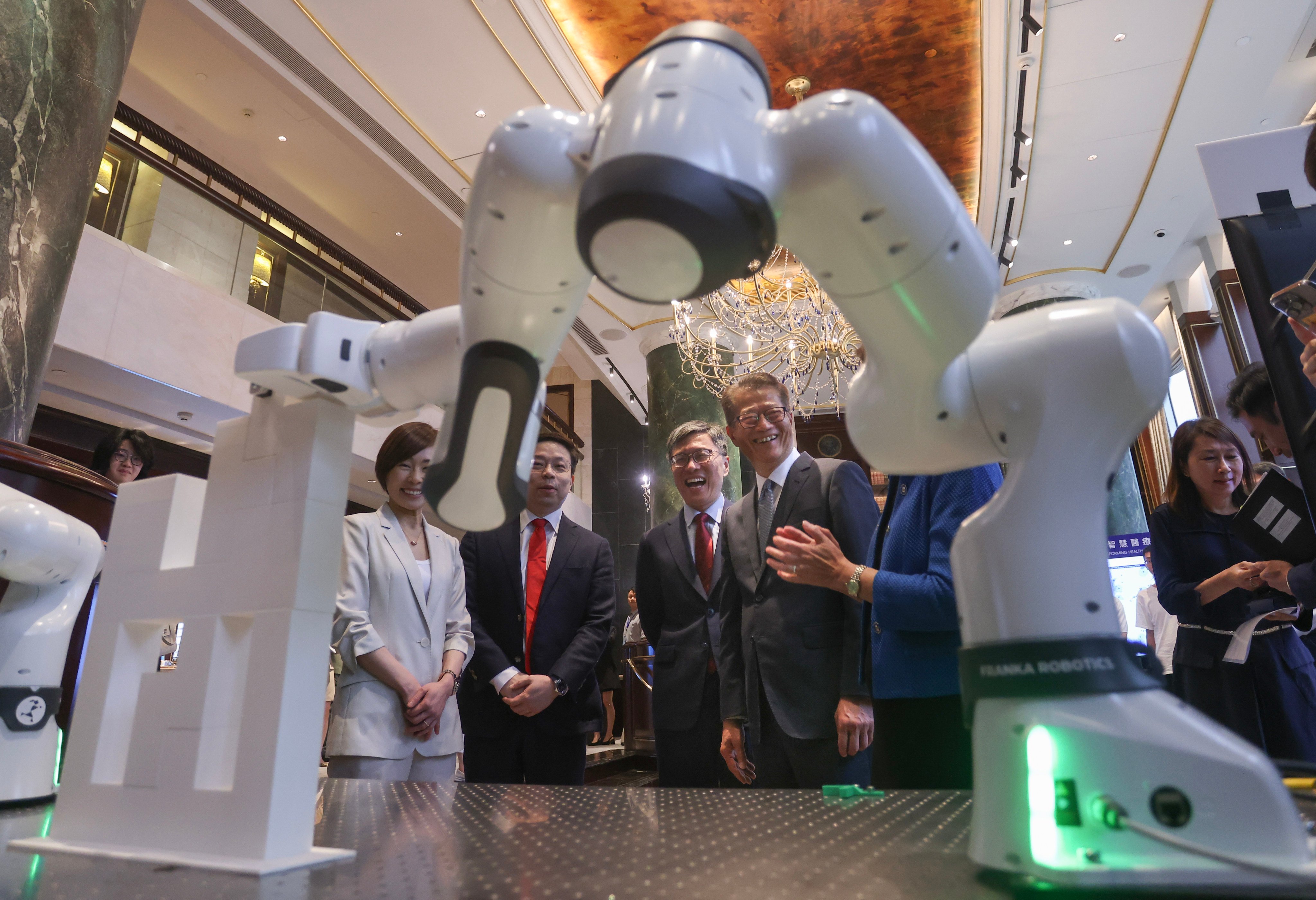 Robot technology is displayed at the inauguration ceremony for the Von Neumann Institute, established by the Hong Kong University of Science and Technology to drive AI innovation. The ceremony, held on May 9, was   attended by Financial Secretary Paul Chan Mo-po (fourth from left). Photo: Jonathan Wong