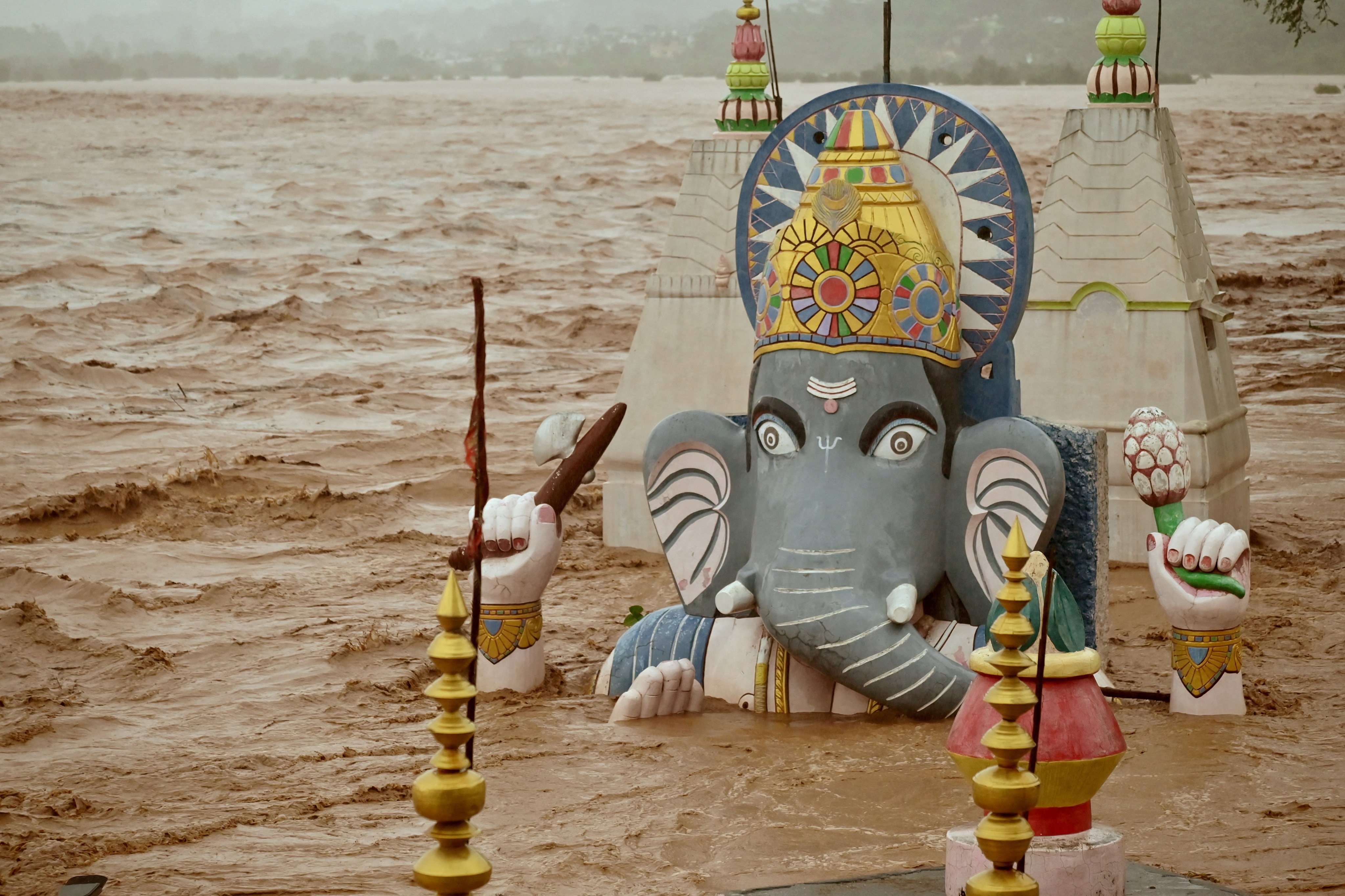 Water from the overflowing Tawi River floods a temple of the Hindu elephant god Ganesh, the deity of prosperity, following heavy rain in Jammu, Indian Kashmir on Tuesday. Photo: Reuters