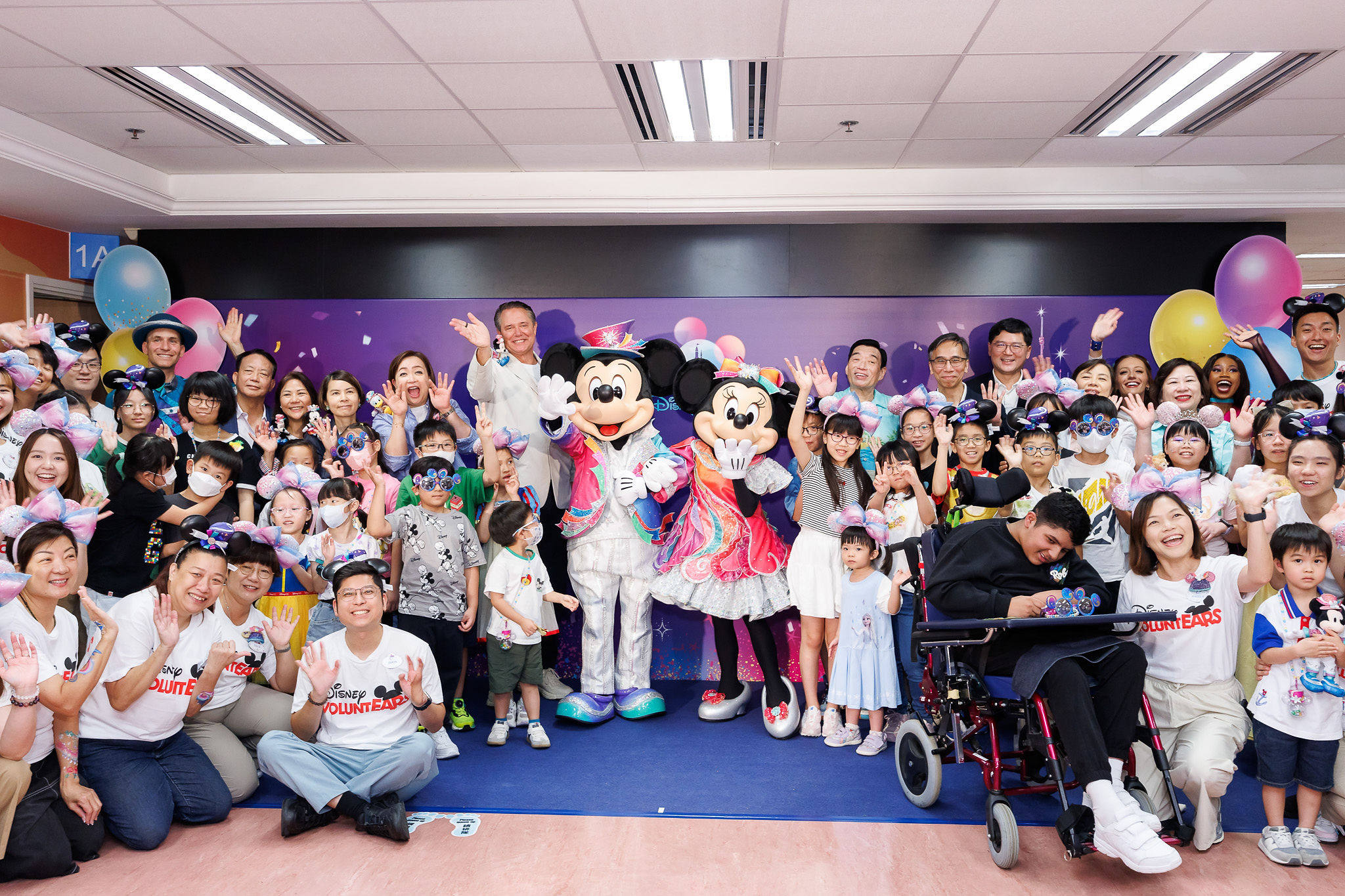 Michael Moriarty, managing director of Hong Kong Disneyland Resort (left of Mickey Mouse), joins child patients and their families at the party held at Tuen Mun Hospital’s Disney-themed Paediatrics and Adolescent Medicine Specialist Out-patient Clinic.