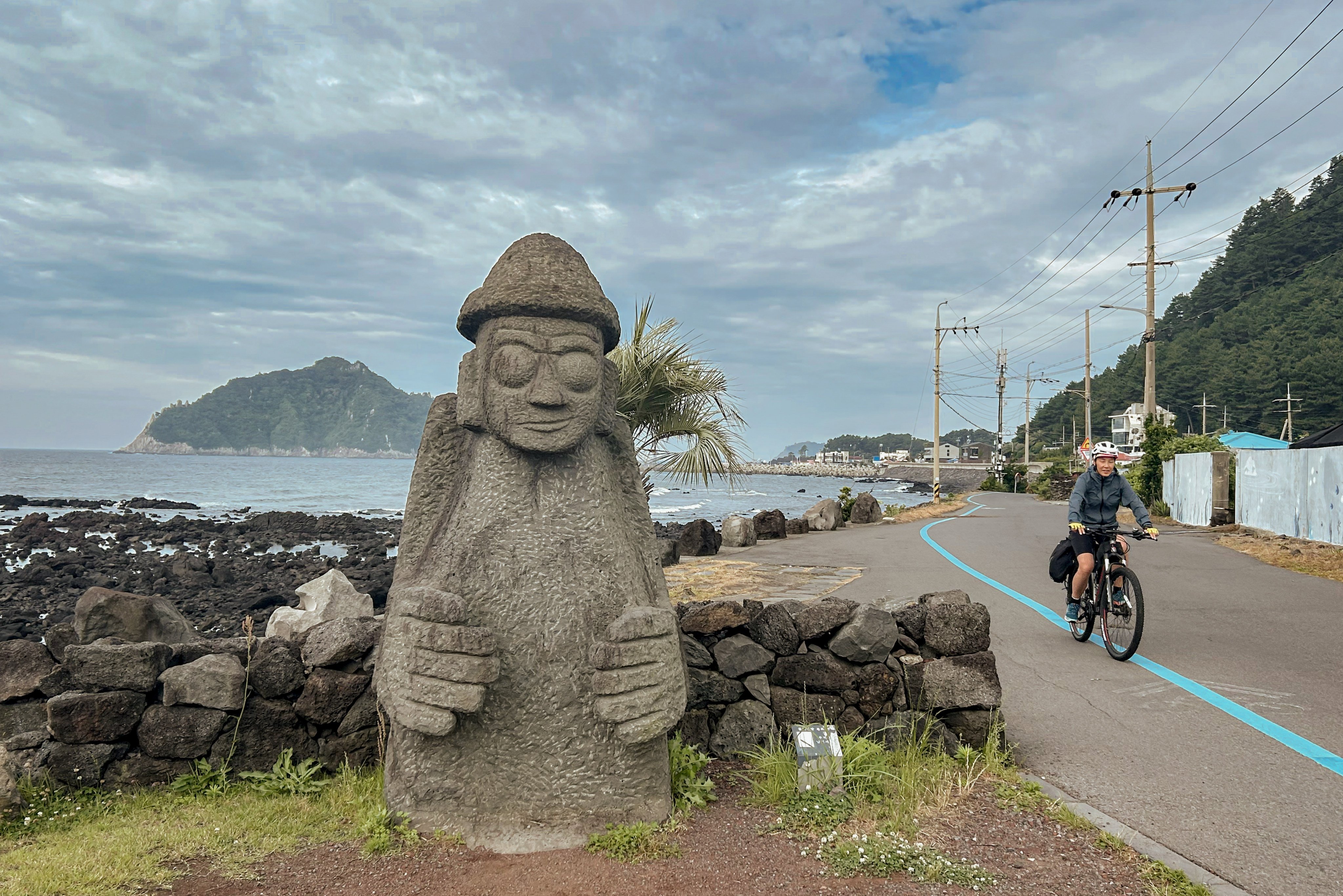 A cyclist follows the blue line that marks the Jeju Fantasy Bicycle Path, which circumnavigates the South Korean island. Photo: Cameron Dueck