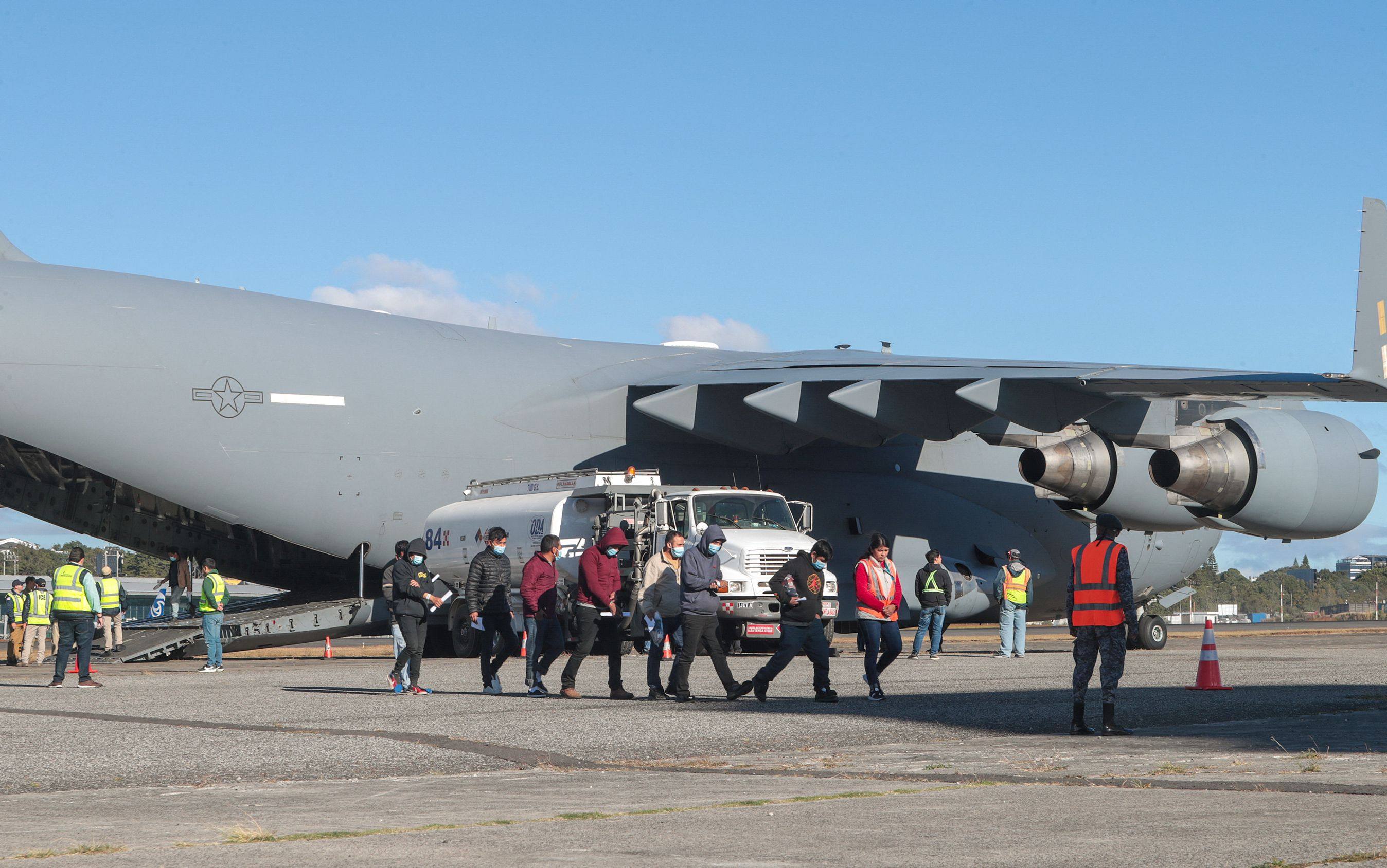 Guatemalan migrants descend from a US military plane after being deported from the US at the Guatemalan Air Force Base in January.
Photo: Guatemalan Migration Institute/AFP