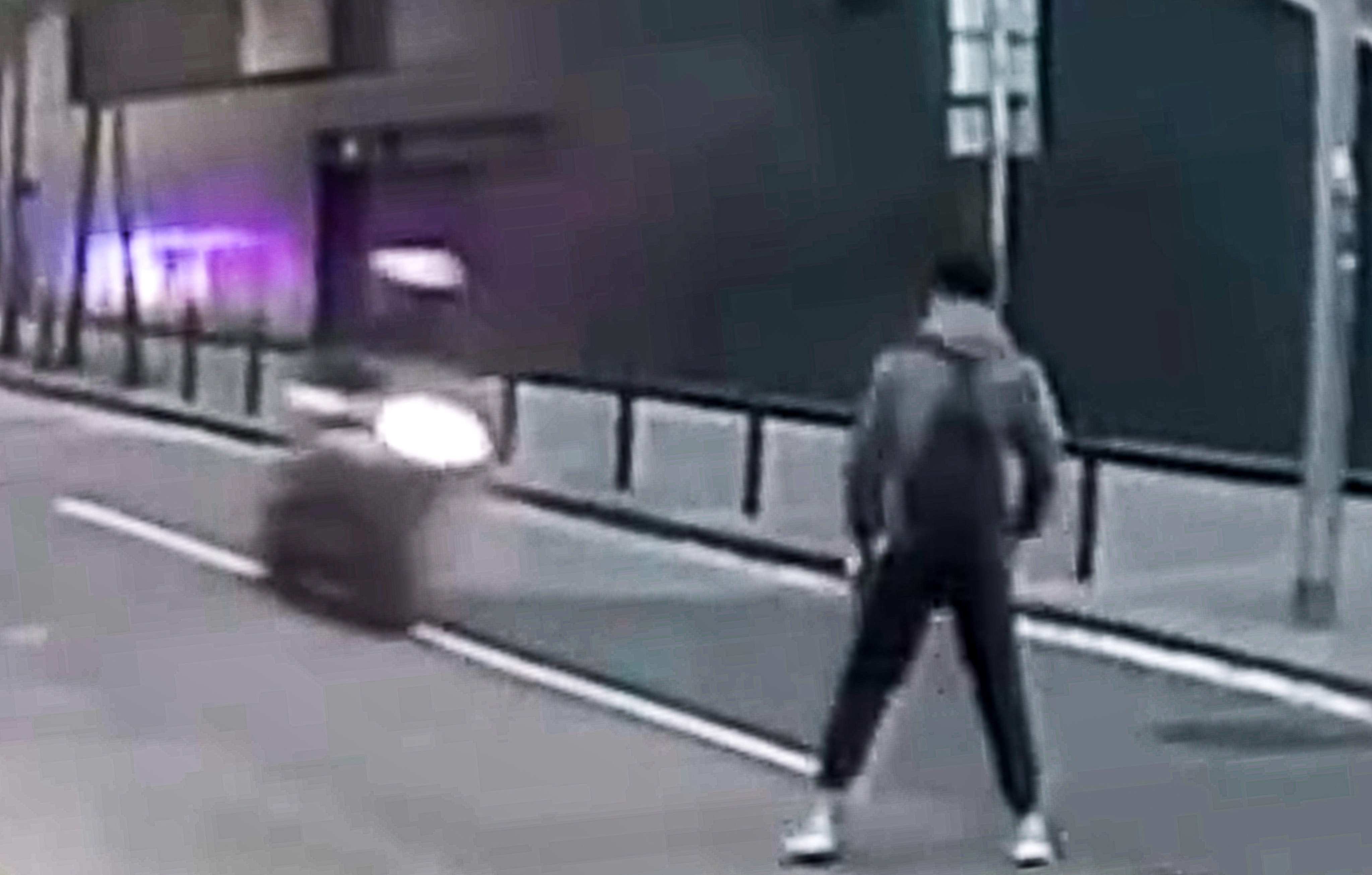 Dashcam footage shows the off-duty officer standing in the middle of the road as the biker approaches. Photo: Handout