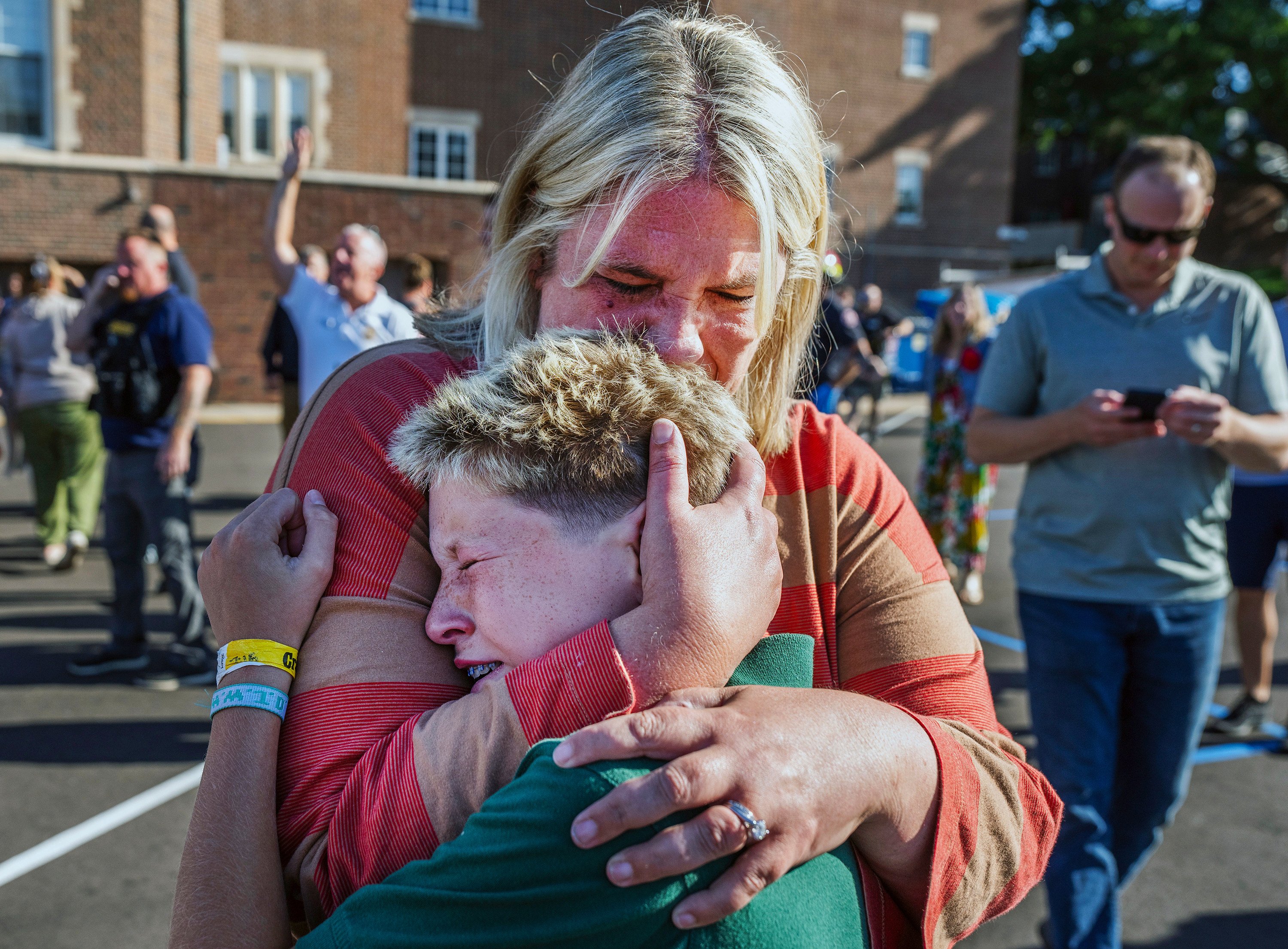 A parent hugs her son during an active shooter situation at the Annunciation Church in Minneapolis, Minnesota, on Wednesday. Photo: Star Tribune via AP
