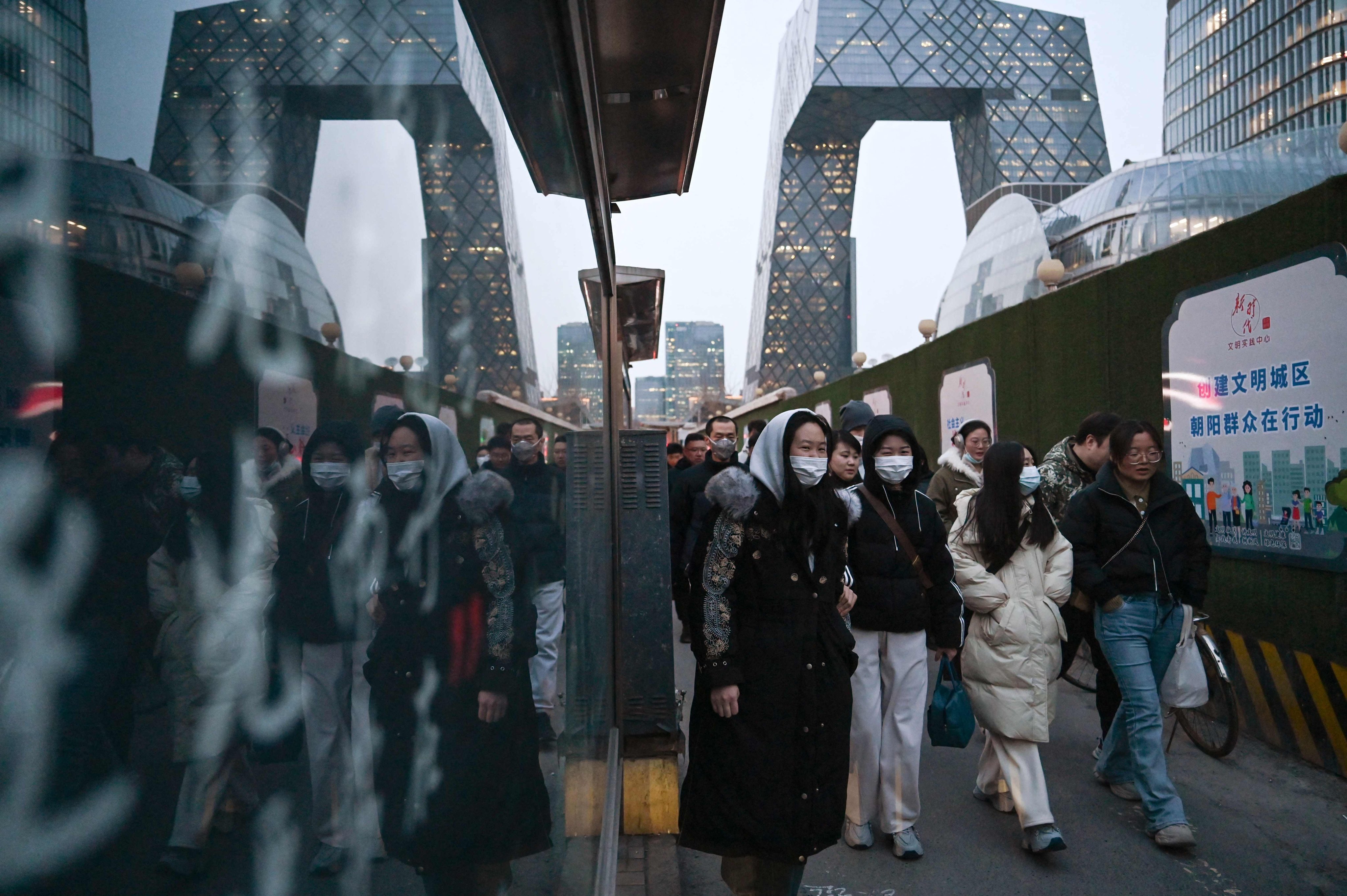 People walk through Beijing’s central business district. Photo: AFP