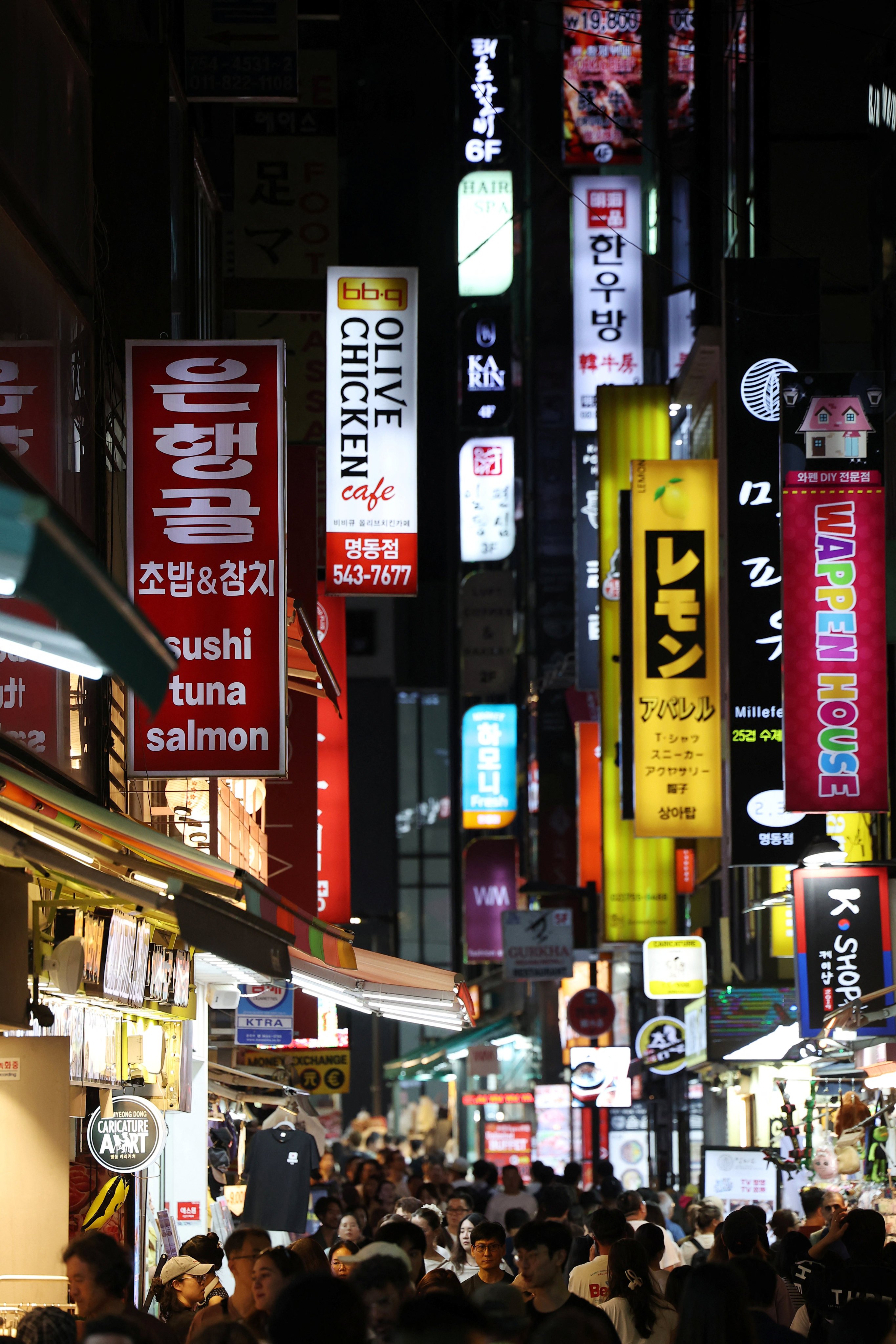 People walk through a crowded street in the Myeong-dong shopping district of Seoul on August 5. Photo: Reuters