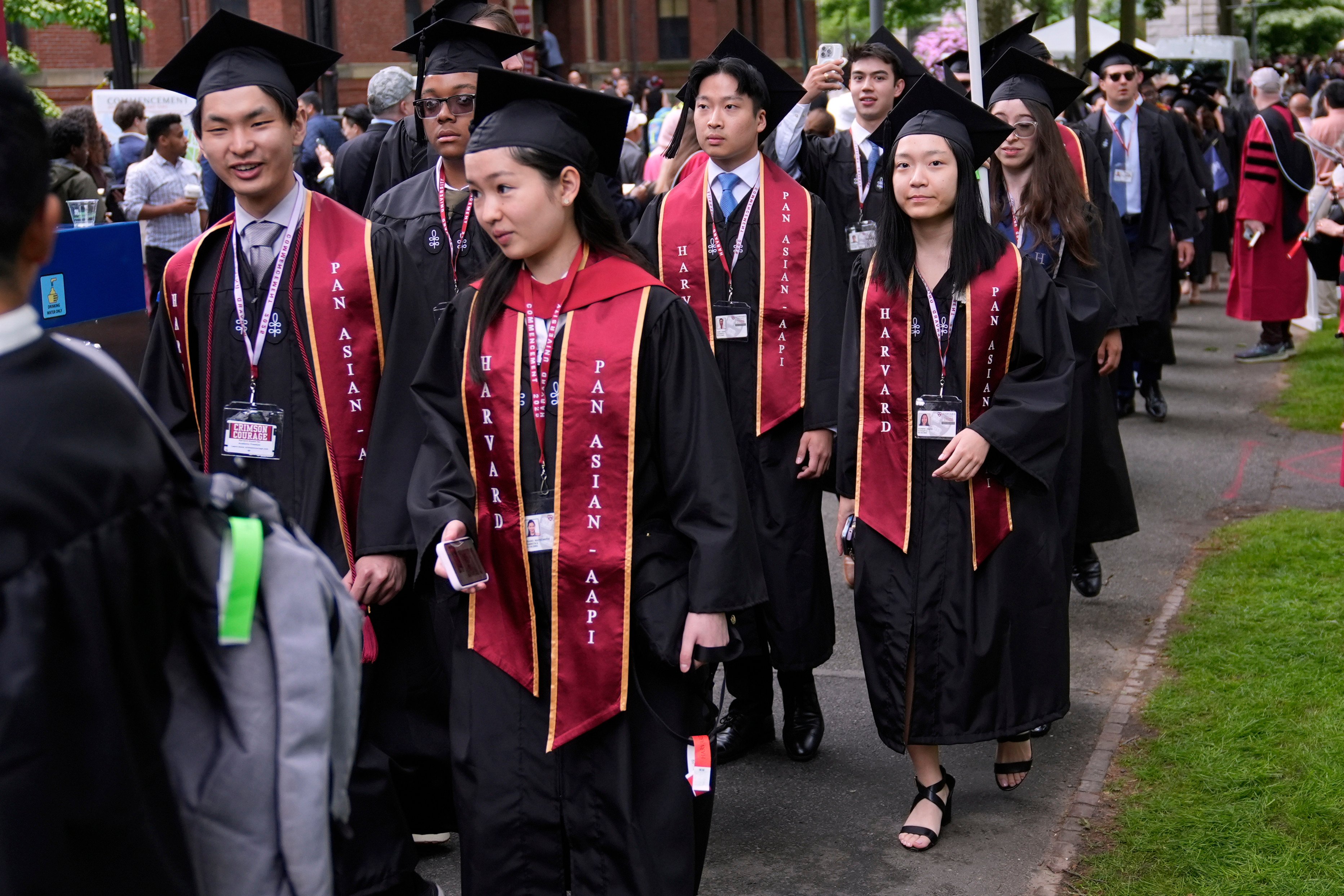Students proceed through Harvard Yard during commencement ceremonies at Harvard University in May. Photo: AP