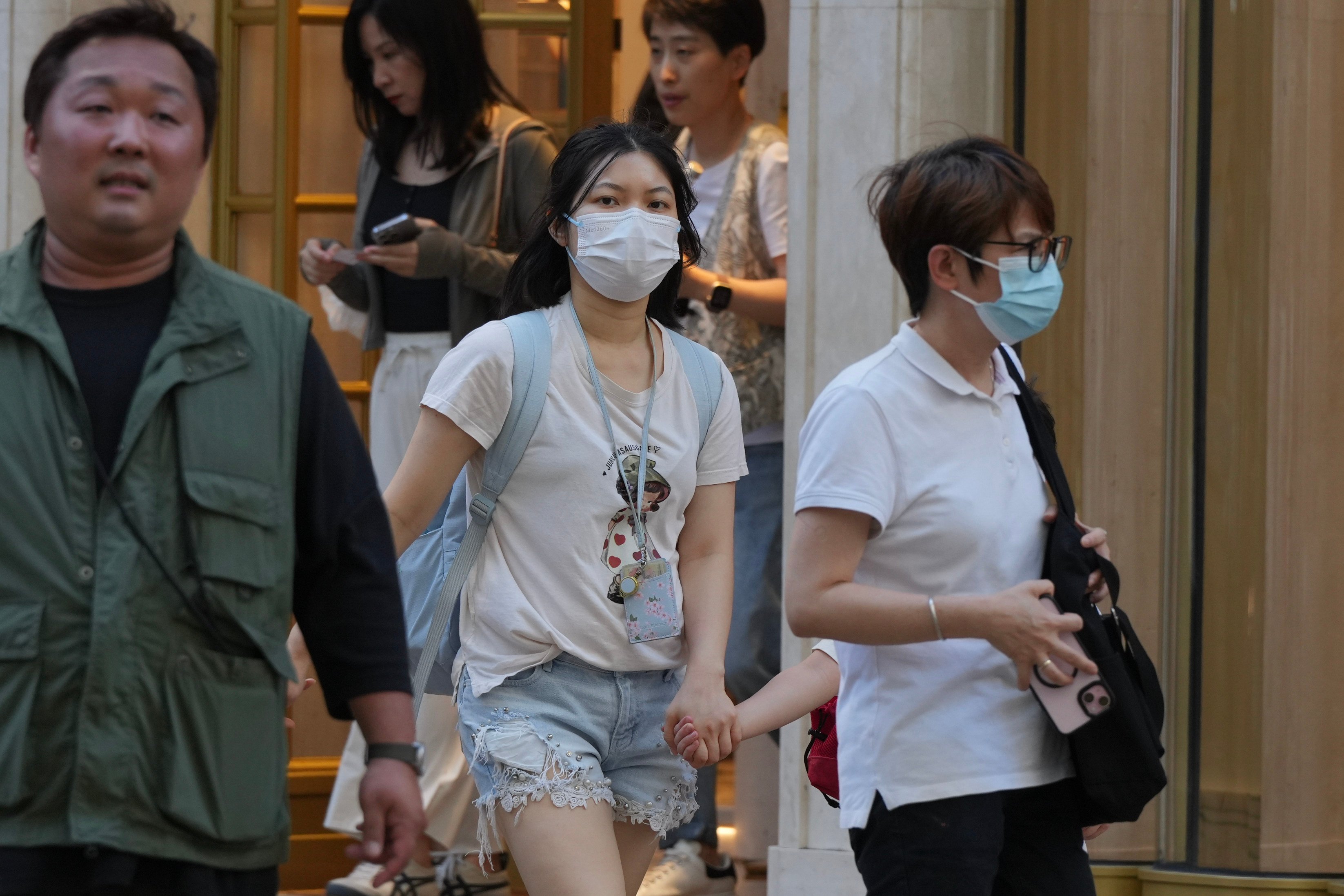 People wearing masks for protection in Tsim Sha Tsui on May 15 after the city’s health authorities announced they had recorded 30 Covid-19-related deaths among 81 severe adult cases in four weeks. Photo: May Tse