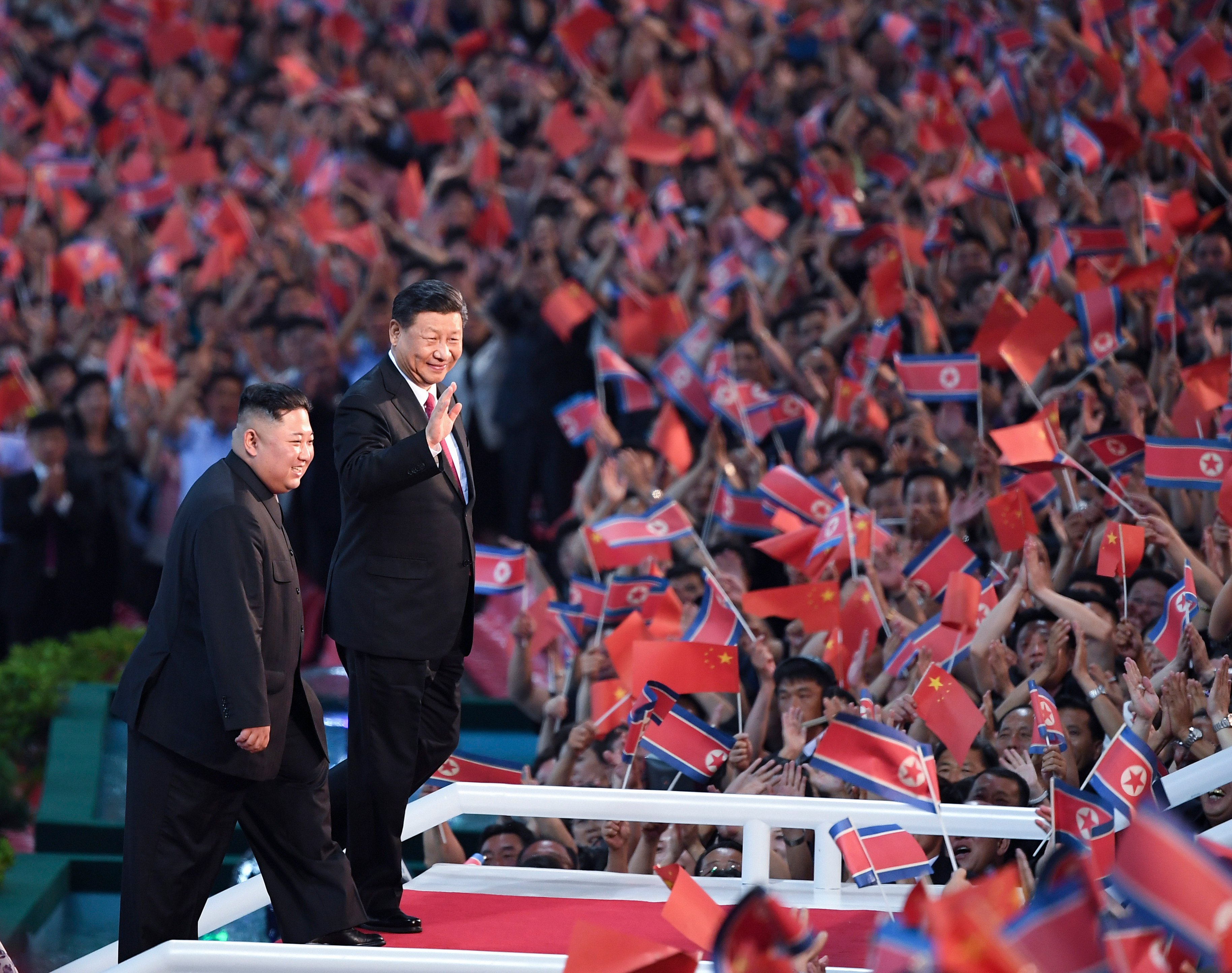 Chinese President Xi Jinping and North Korean leader Kim Jong-un wave to a crowd in Pyongyang in June 2019 – the last time the two leaders met in person. Photo: Xinhua
