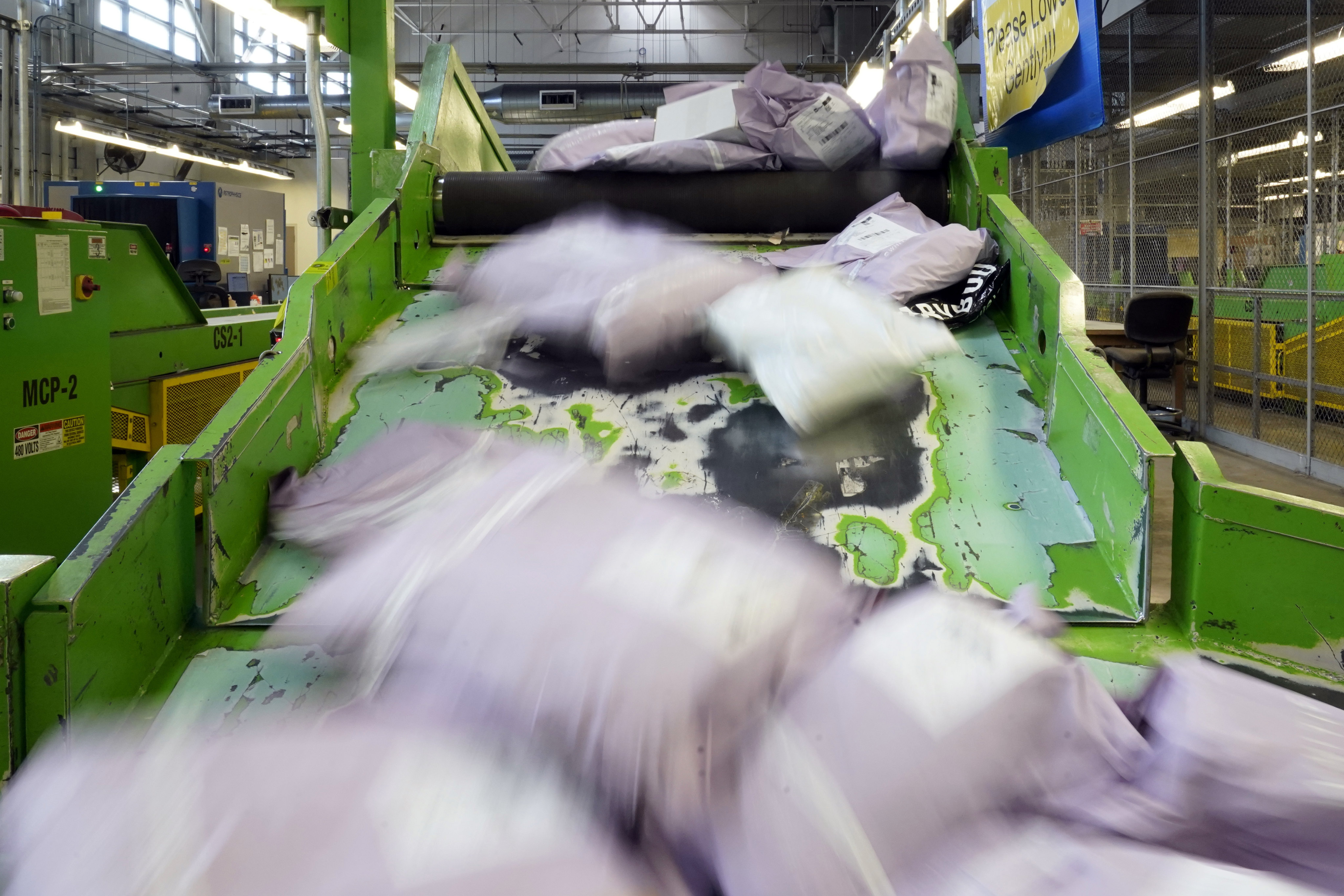 Parcels slide down a ramp after being scanned at the US Customs and Border Protection overseas mail inspection facility at Chicago’s O’Hare International Airport in February last year. Photo: AP