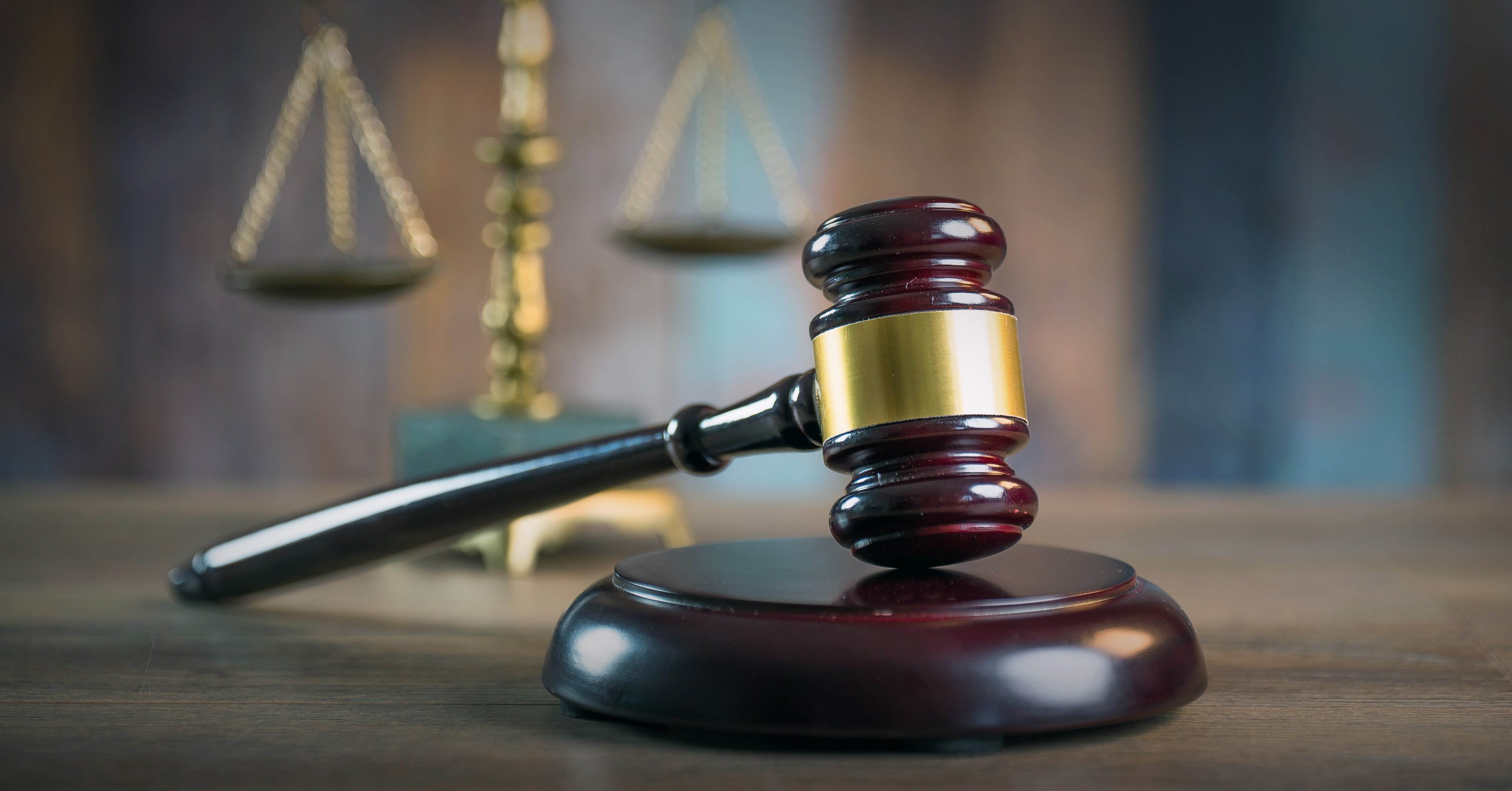 A judge’s gavel is pictured, with the scales of justice in the background. The suspects in the case were ordered to surrender their passports and stay away from the victims. Photo: Shutterstock
